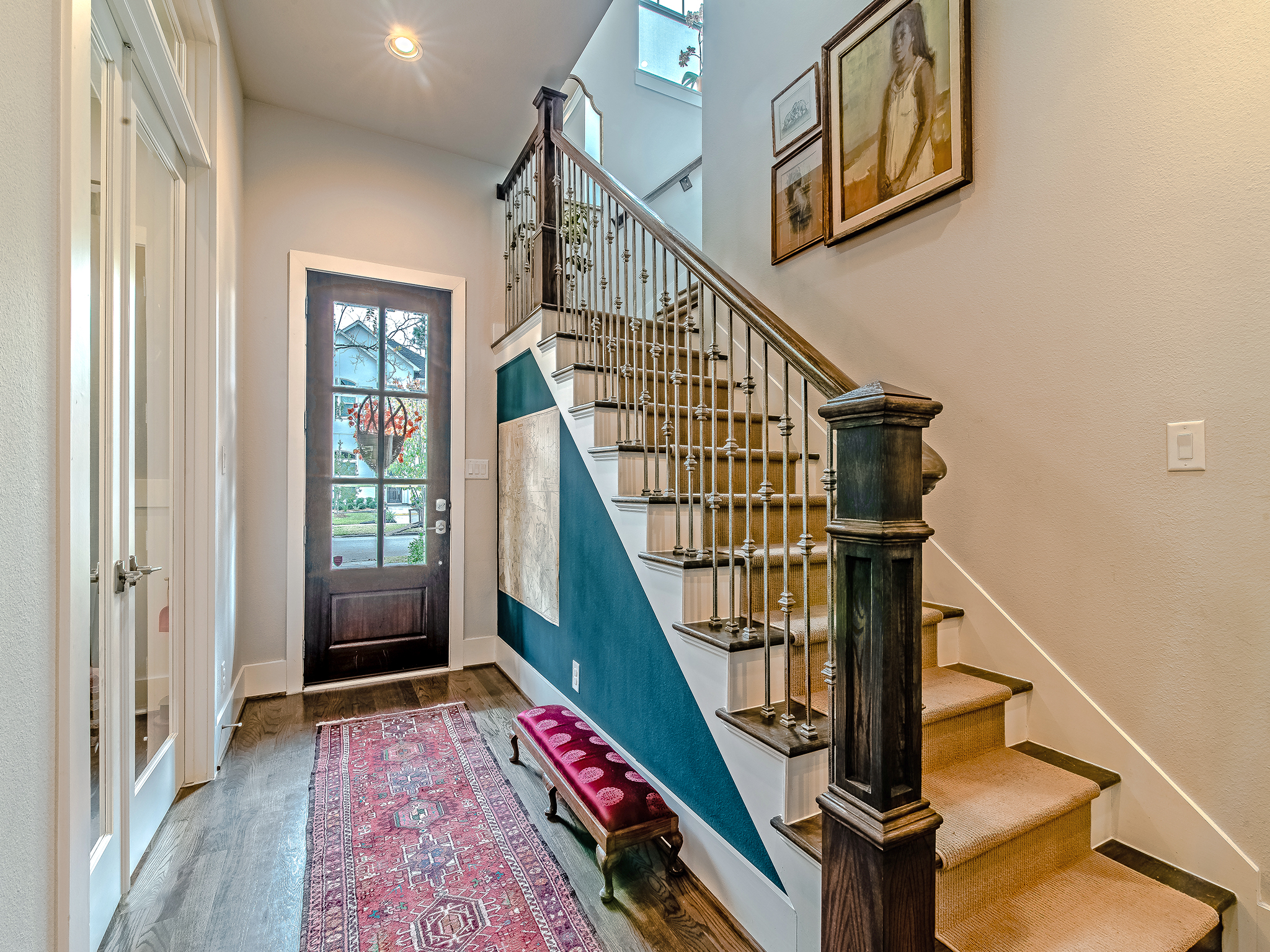  Inviting entry features gleaming hardwoods, soaring ceiling and wrought iron stair case. Just off the entry is an office space that is currently being used as a playroom. 