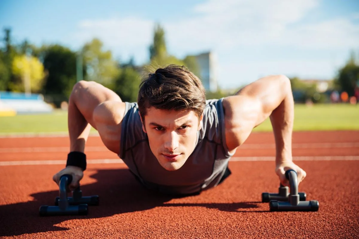 graphicstock-young-male-athlete-makes-push-ups-on-a-racetrack-at-the-stadium_B_zFR1XBhe (1).jpg