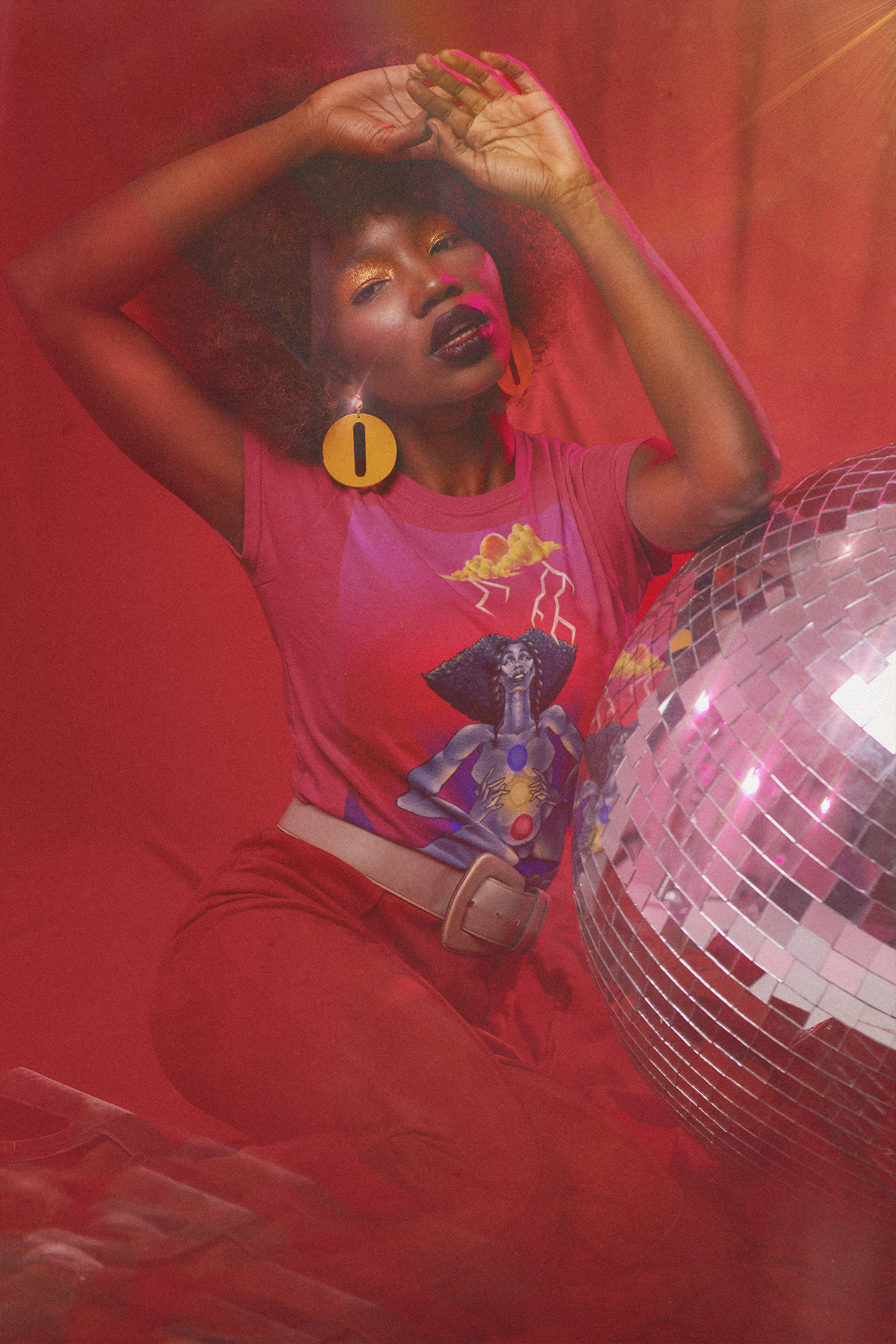 t-shirt-mockup-of-a-serious-woman-in-a-70s-outfit-posing-by-a-disco-ball-m10145.png