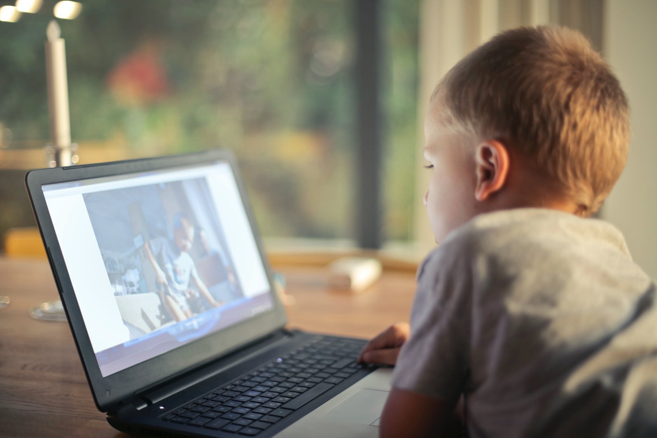 Boy on Computer at Home on Table.jpeg