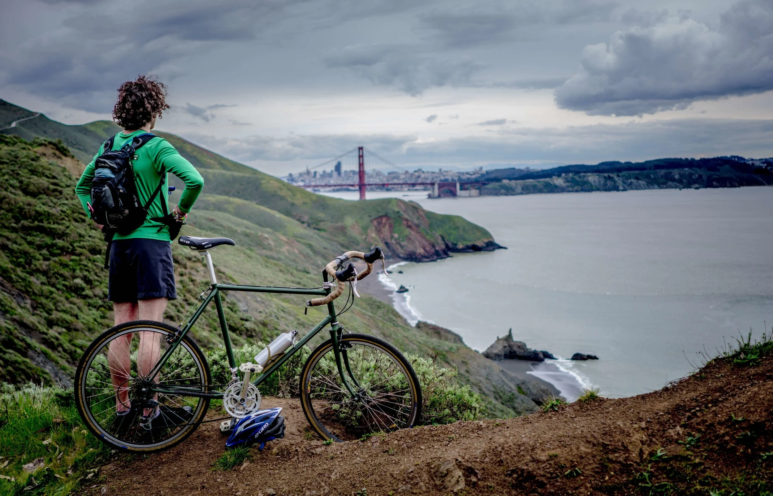 guy on bike looking at san francisco bridge