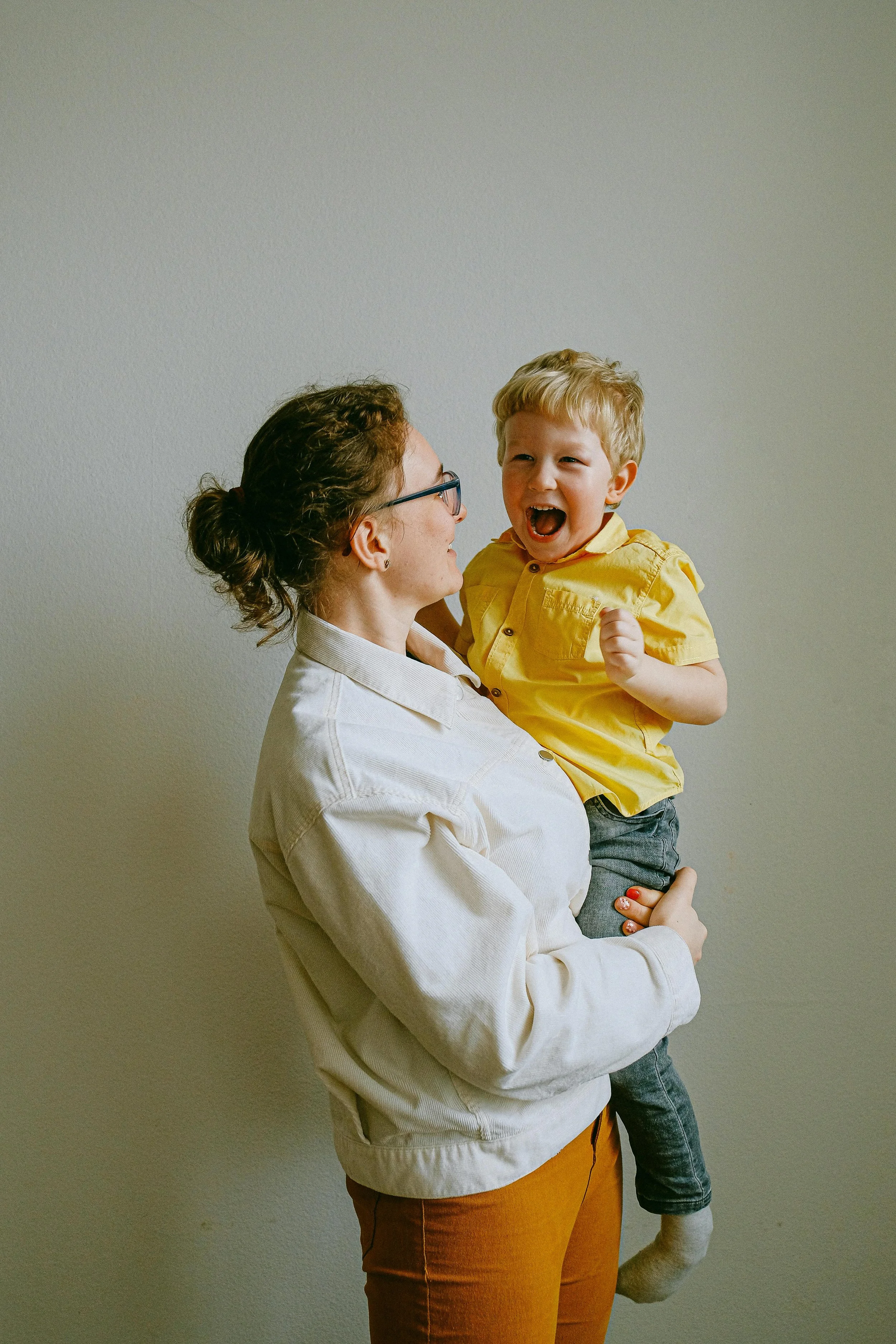 A woman holding and laughing with her young son, representing fertility support for single mothers by choice at South Shore Acupuncture and Wellness, Rockland MA.