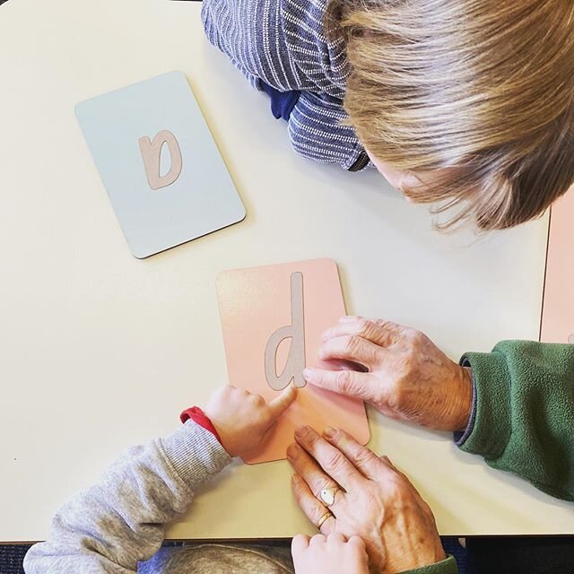 Sandpaper letters are one of the more recognisable Montessori materials. The children trace the letters as they say the sounds.