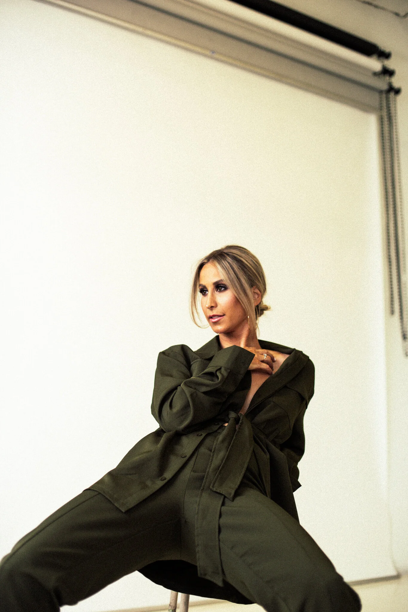  Photograph by: Jackie Sterna. Hair + Makeup by: Amanda Martinez Kelley. Edit by: Catie Menke. Location: Blok Photo Studios. Olive Suit:   PrettyLittleThing  . 