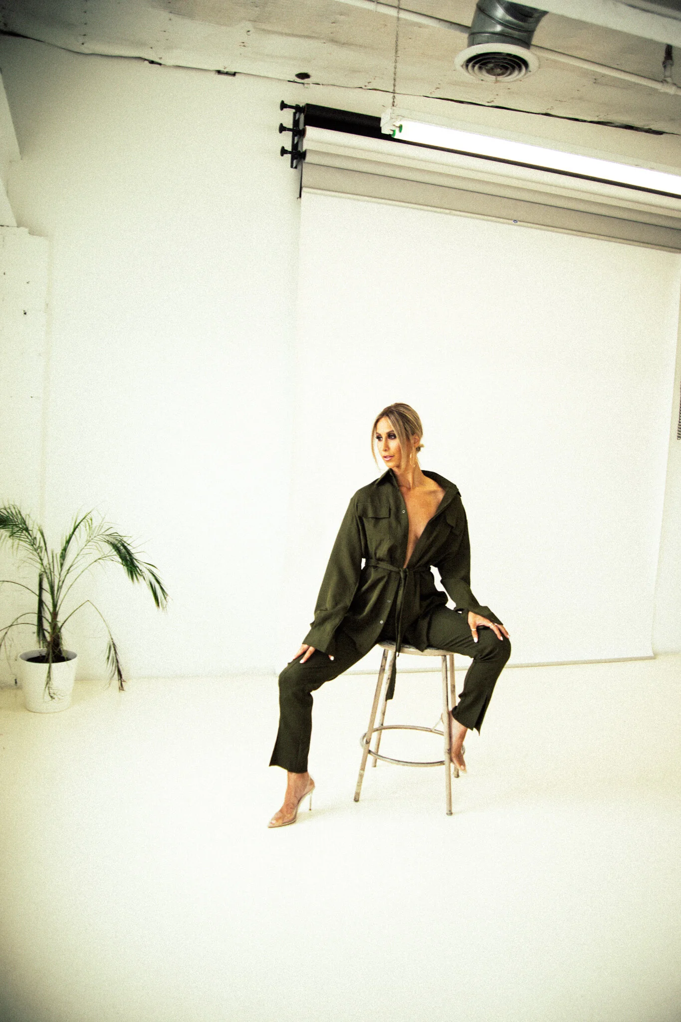  Photograph by: Jackie Sterna. Hair + Makeup by: Amanda Martinez Kelley. Edit by: Catie Menke. Location: Blok Photo Studios. Olive Suit:   PrettyLittleThing  . 