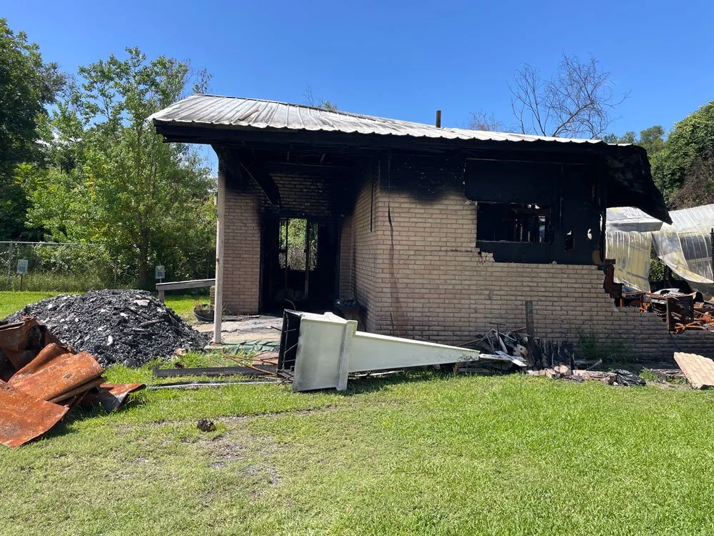 burned building with debris and steeple on ground