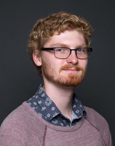 A portrait photo of director Landon Coats