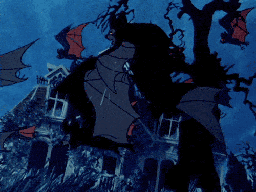 Animated bats flying in front of a spooky haunted house.