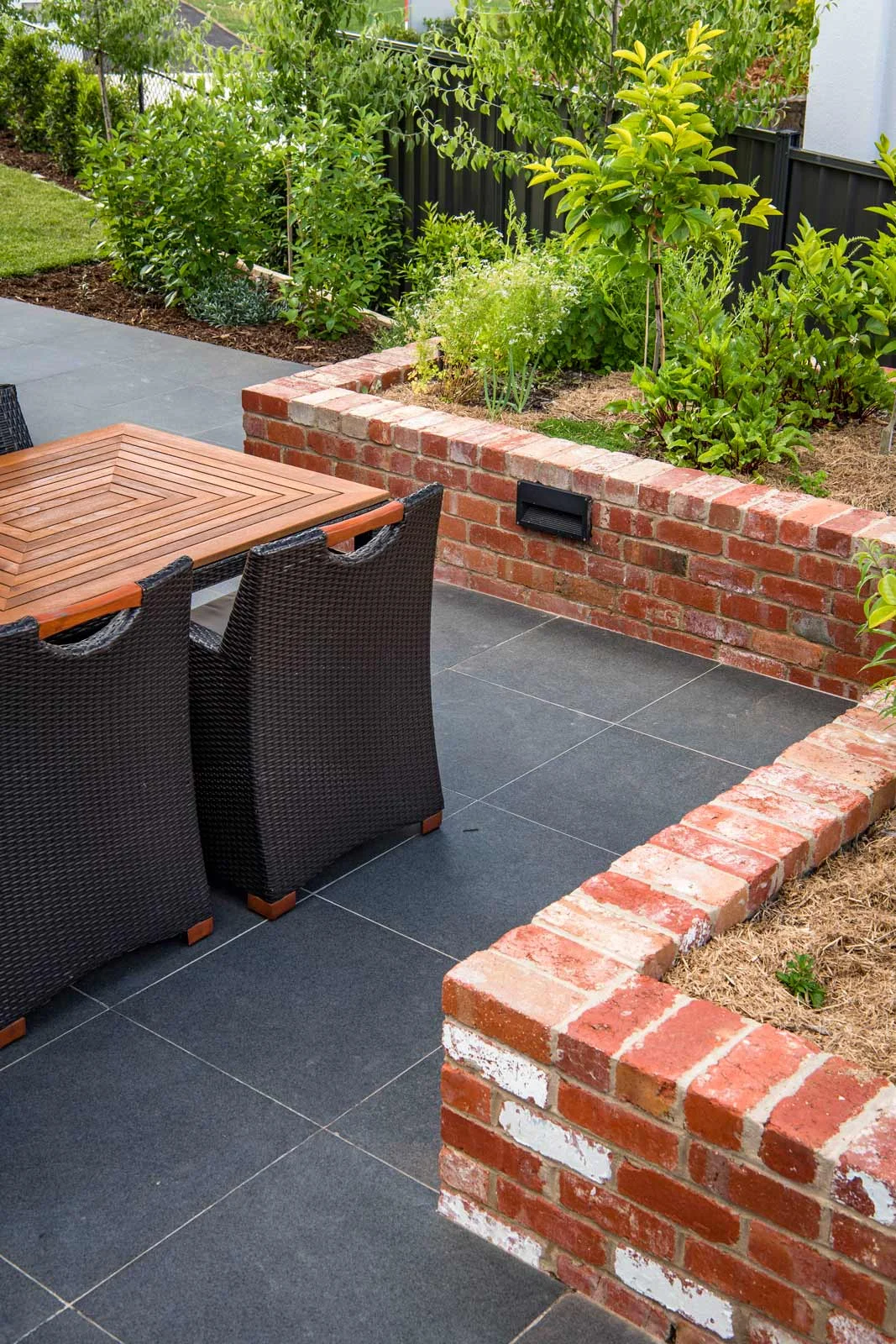 zig zag brick planter bed with edible garden