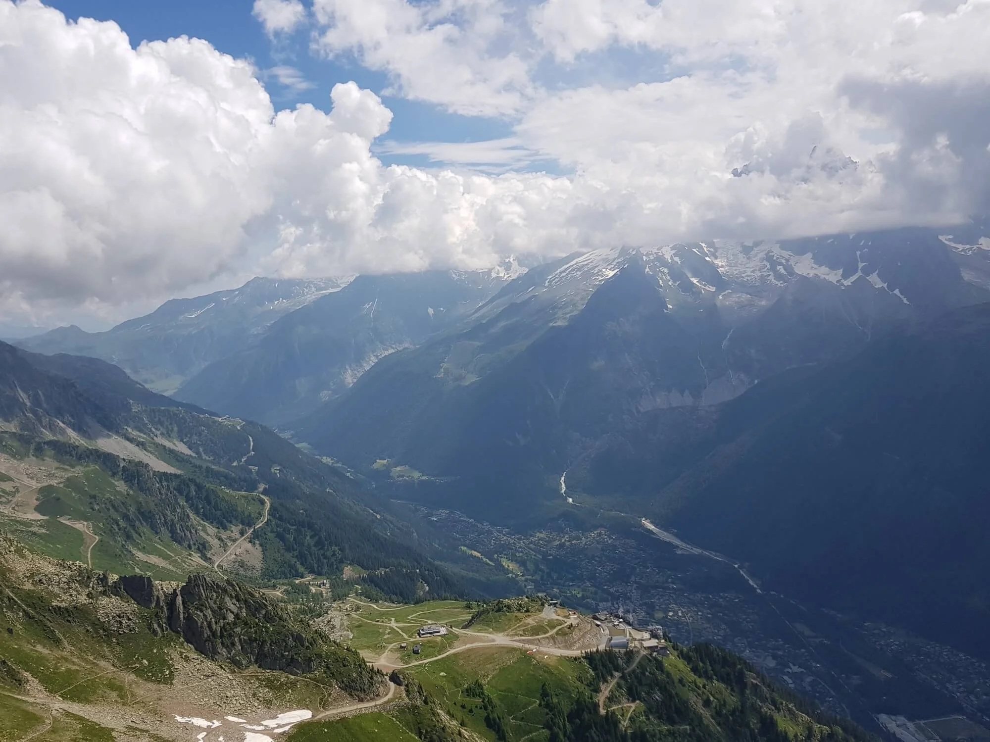 Le Brévent: Looking down on the Plan Praz gondola which connects the ski area with Chamonix. Mont Blanc across the valley with the top hidden by clouds