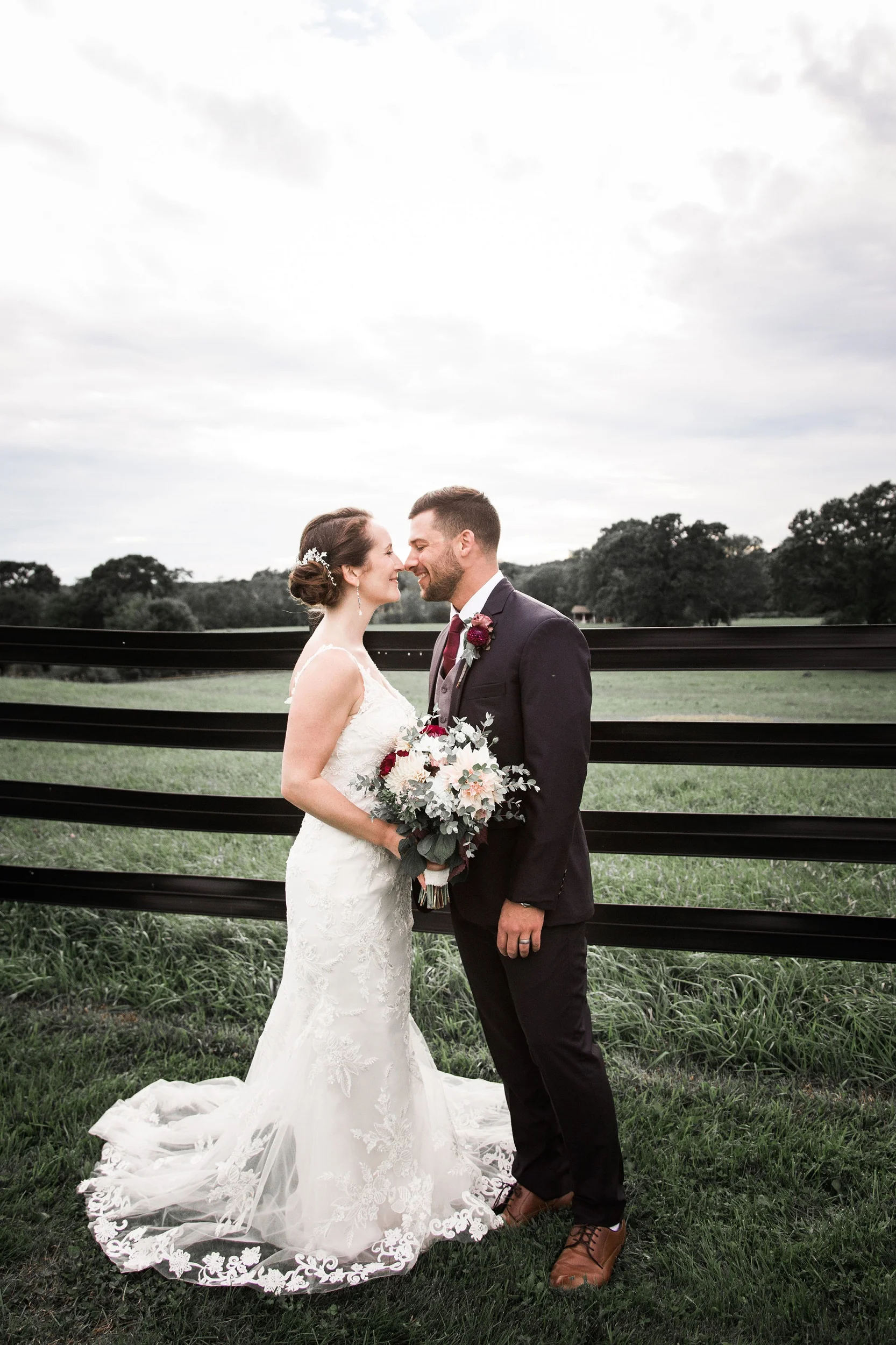 bride.groom.bouquet.fence.jpg