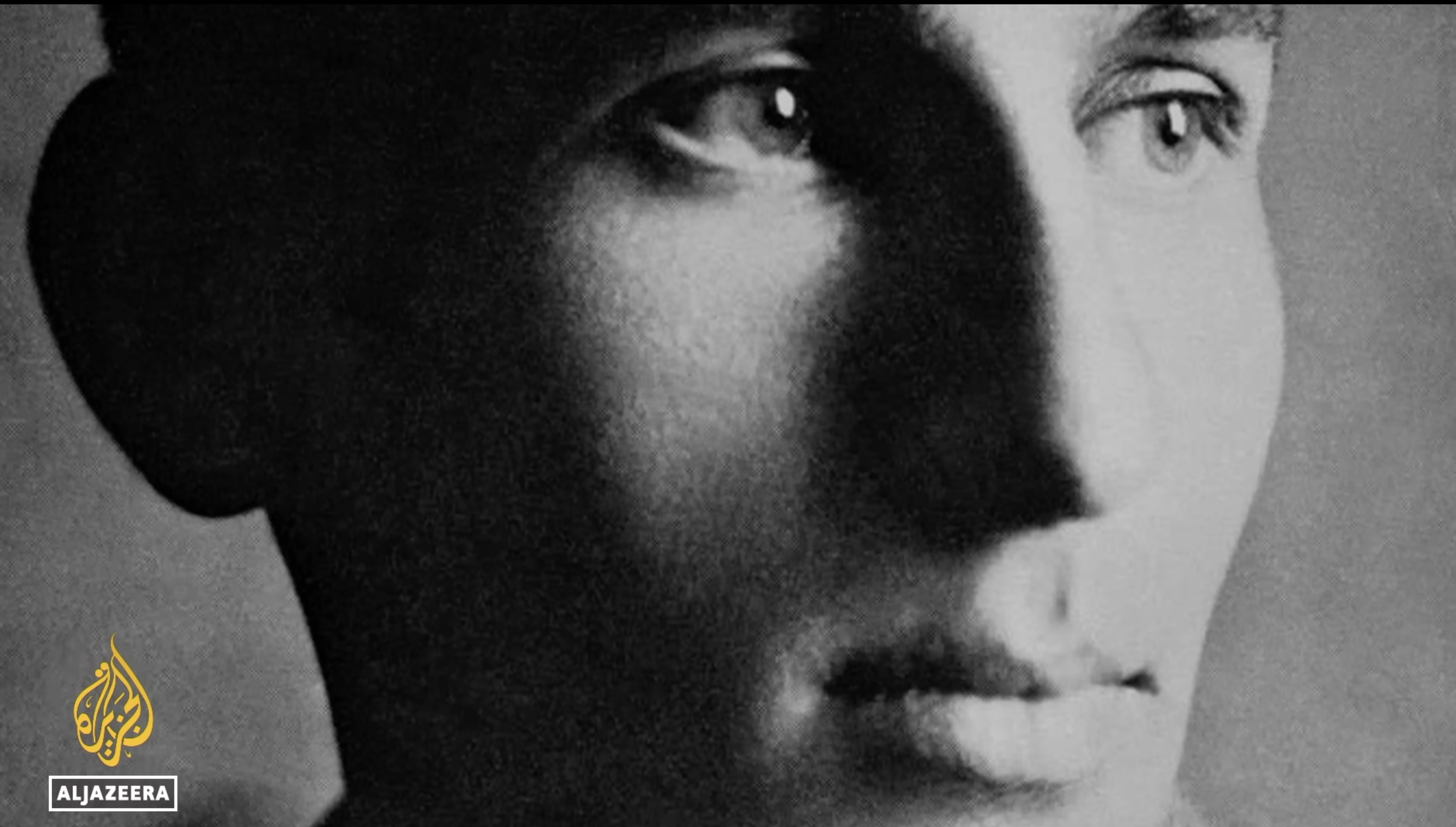 Close-up black-and-white photo of a woman's face with a shadow over one eye, showing a thoughtful expression. The Al Jazeera logo is in the bottom left corner.
