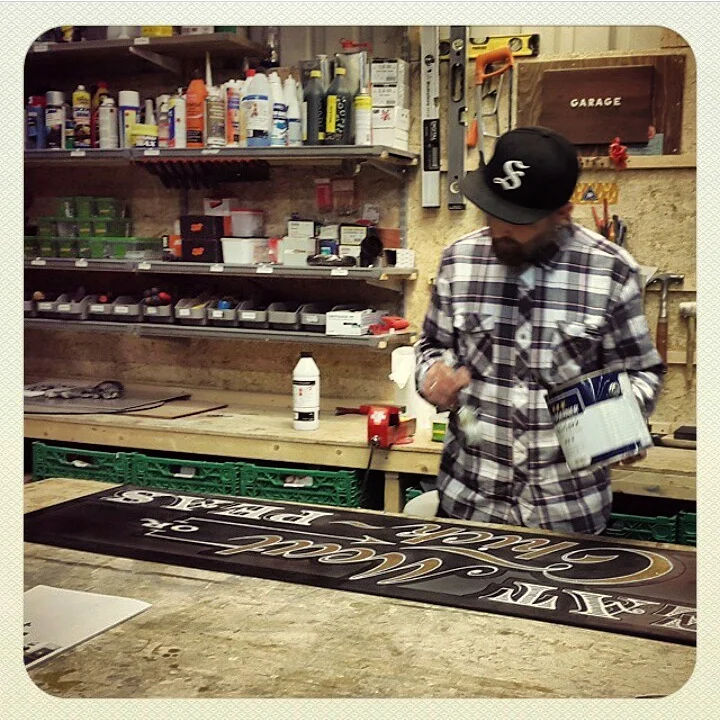 In the lab, painting a sign.