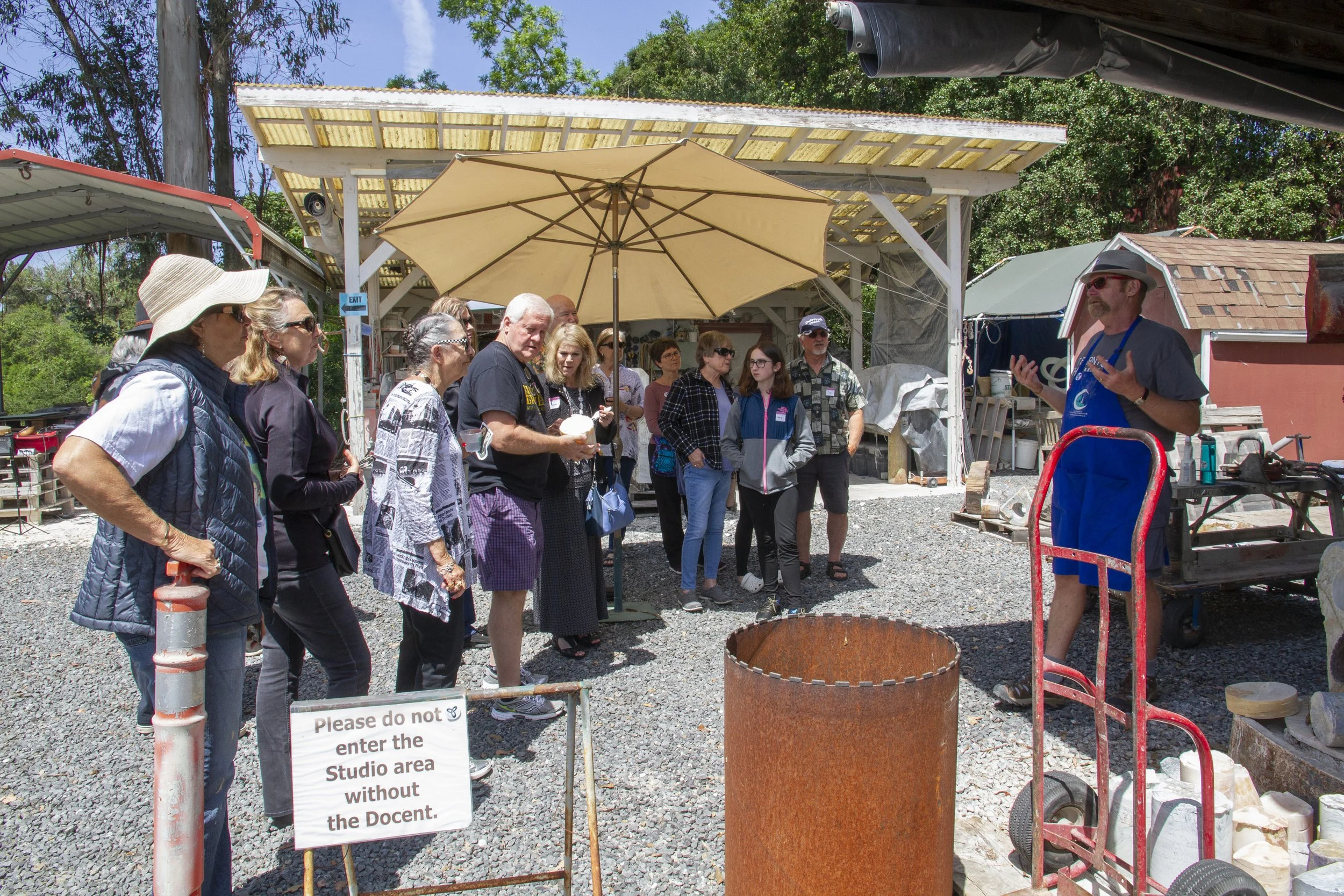  T Barny explaining the fine art of stone carving to studio visitors 