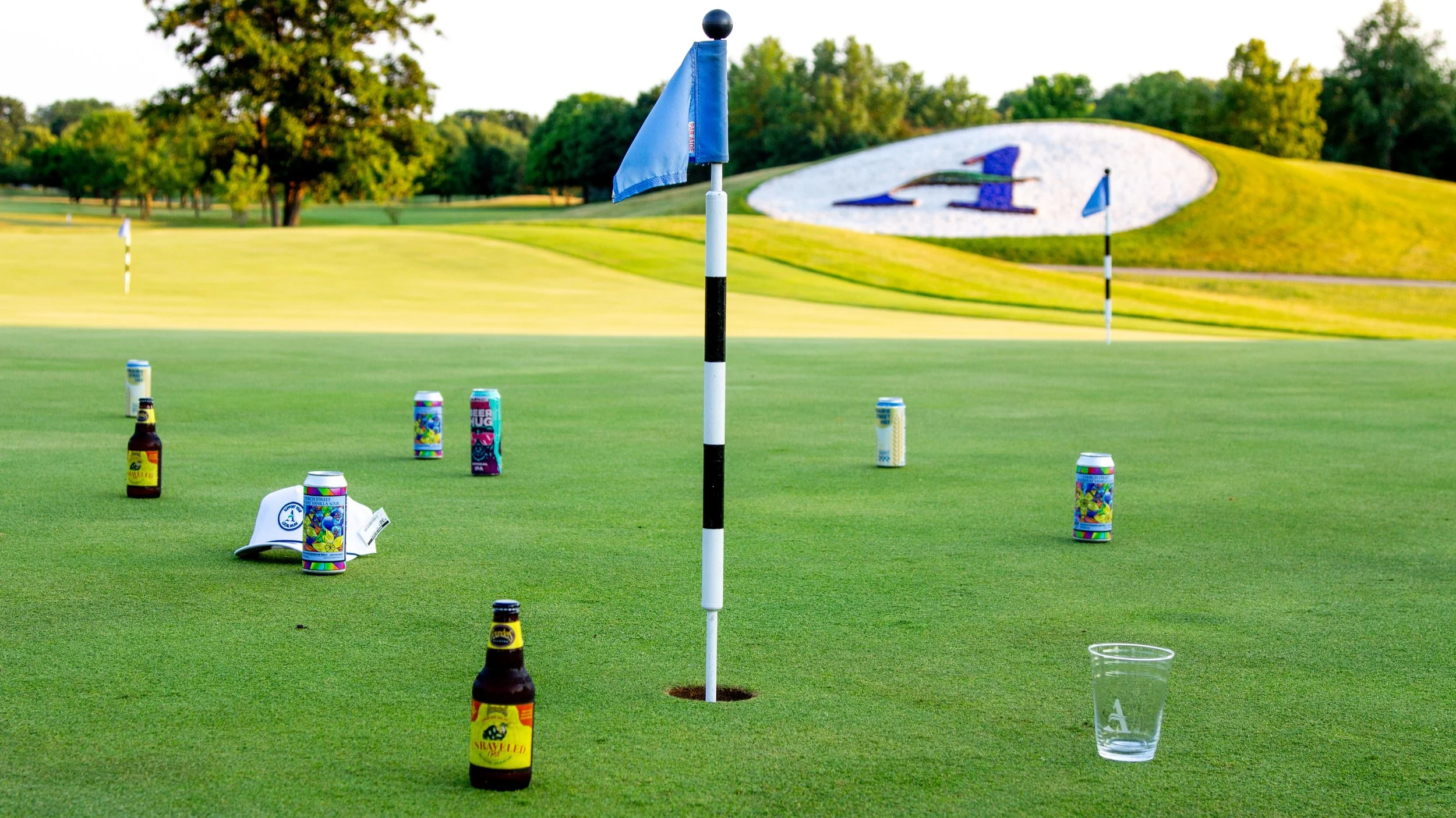 Putting green with beer bottles.