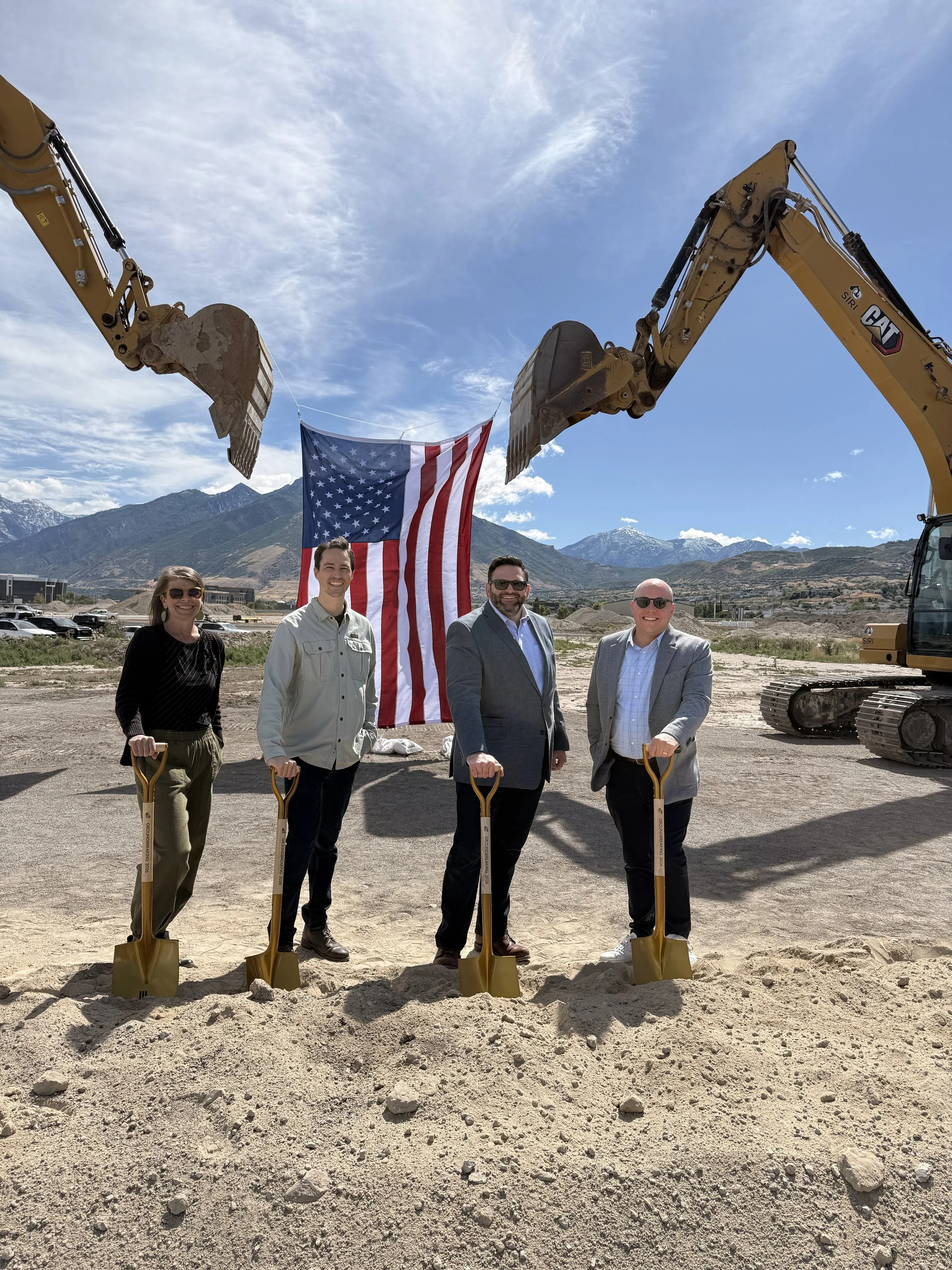 Image of the Envision Utah team shoveling dirt at The Point groundbreaking in June 2026. A construction site is seen with four Envision Utah team members, including Jason Brown, CEO of Envision Utah.