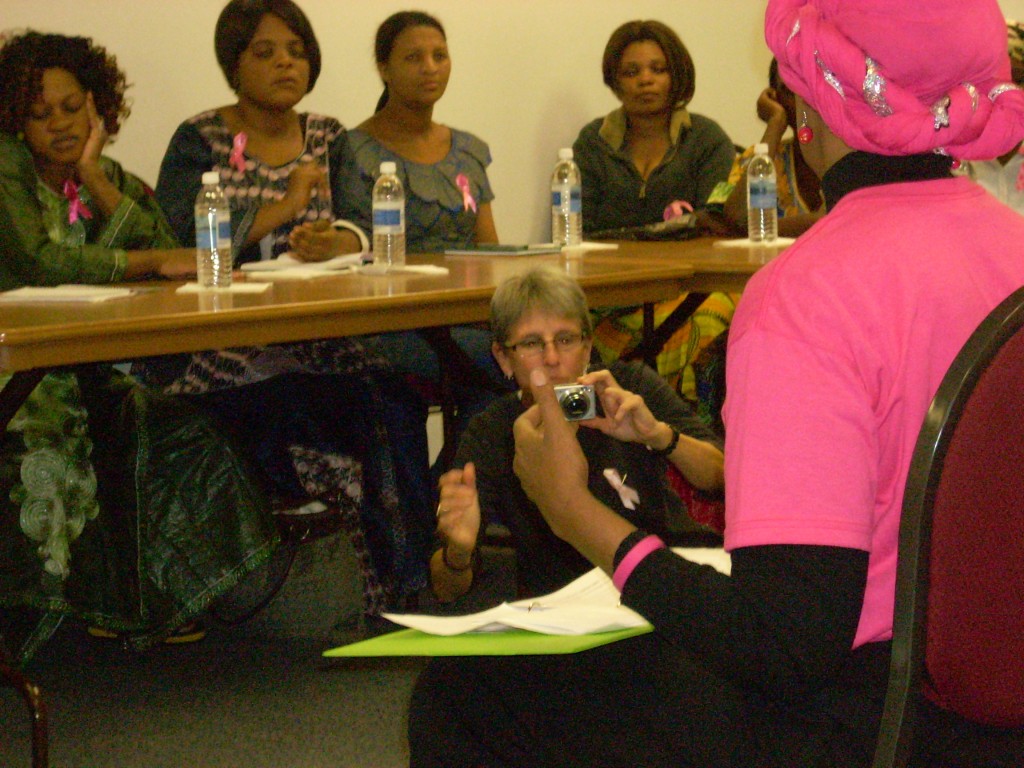 Lisa takes photos as Phillipa teaches African refugee women in Houston about breast health awareness.