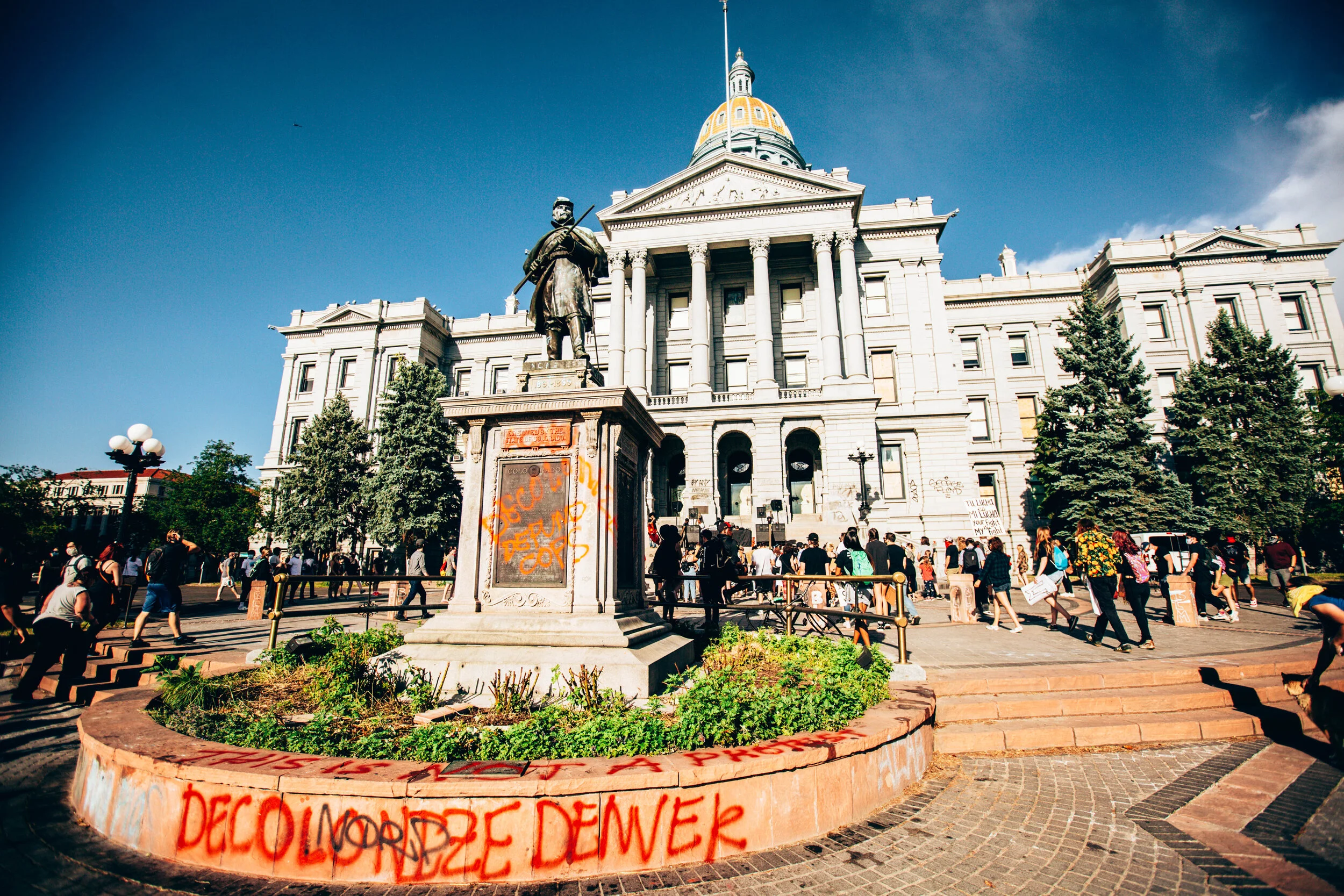 A statue in front of The Capitol Building, Denver, CO reads “Decolonize Denver.” The statue was later dismantled along with many others by protestors in the city.
