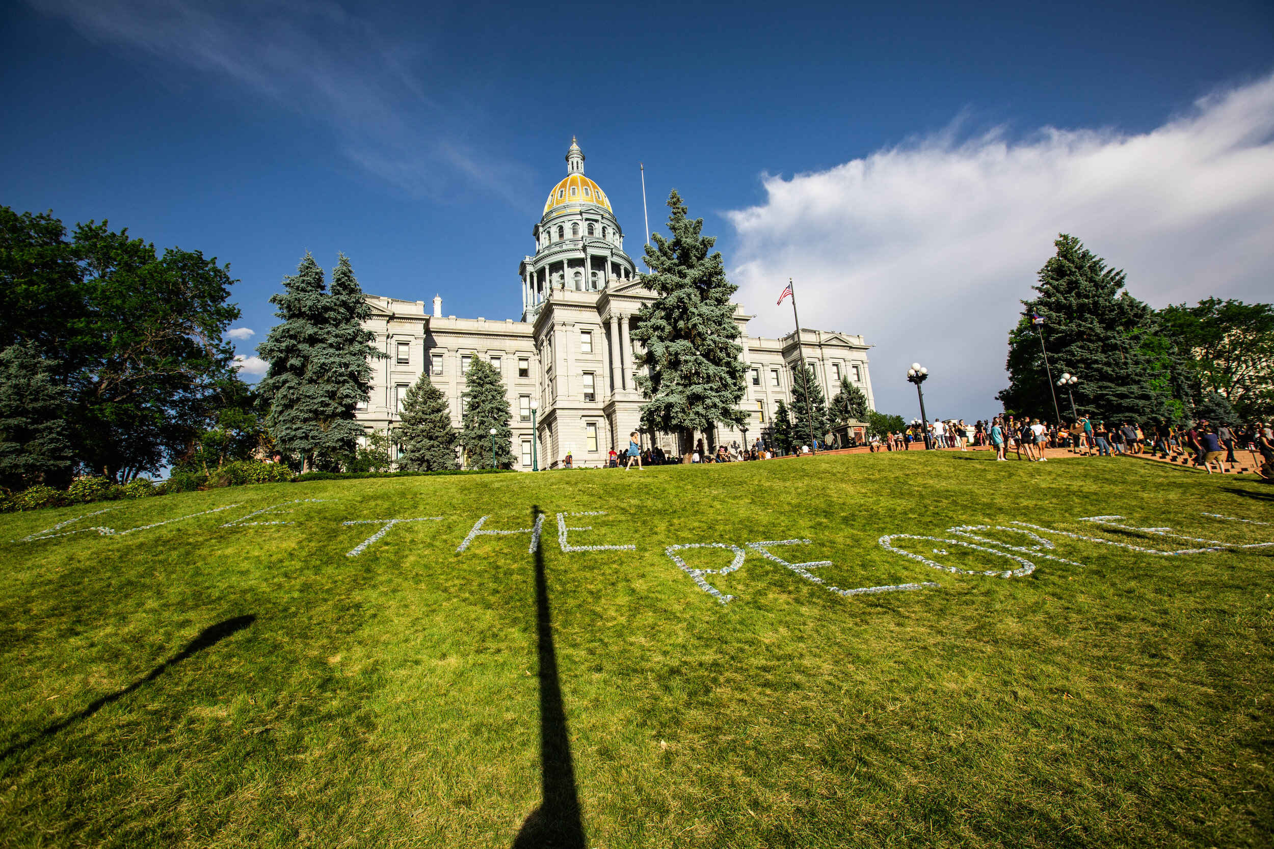 Protestors spell out “We the People” in plastic water bottles on the lawn in front of the Capitol Building in Denver, CO. There was an excess of water bottles from supporters handing out snacks and water to protestors during the Denver Black Lives M…