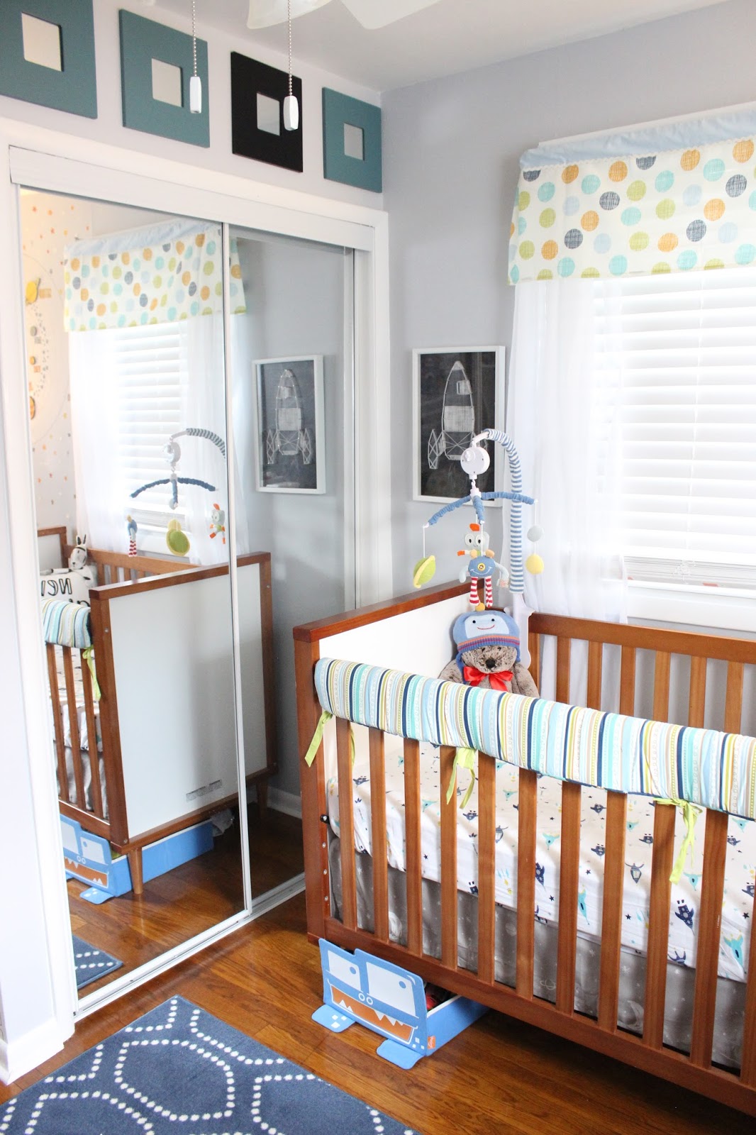 Rocket String Art: Pillowfort for Target Robot/Space Mobile: Lolli Living Bot Dot Window valance: Lolli Living Bot Dot Crib: Babyletto Skip (Appears to be sold out everywhere which is too bad, I love this--even though Rowan has never once slept here. It converts to a toddler bed, so maybe one day?) Square Mirrors: Ikea Malma Under Crib Storage: P'Kolino Monster Rail cover : is actually a reversible crib bumper by Lolli Living Crib Skirt: Dwell Studio Galaxy (seems to be sold out most everywhere, so if you want this, you should scoop it up ASAP) Rocket Sheets: Pottery Barn Kids (discontinued)