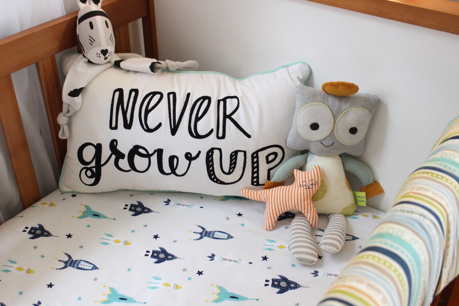 Never Grow Up Pillow: Pillowfort for Target Lovey: River Kippin Robot: Robbie Robot from Lolli Living Cat Rattle: Ikea Leka