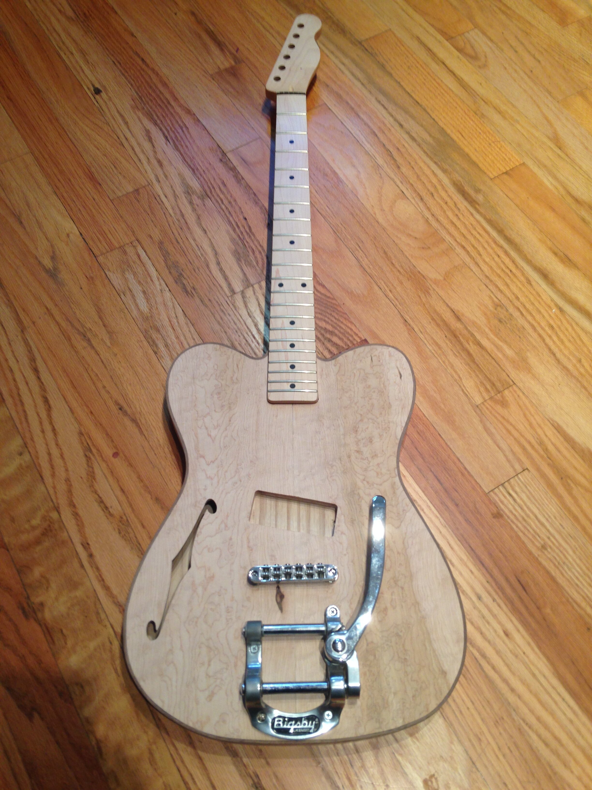 No-Cutaway Tele II  Maple top with some birdseye, ash back, maple neck. P-90 pickup and Bigsby trem bar.  Forest Tate Guitar Builder