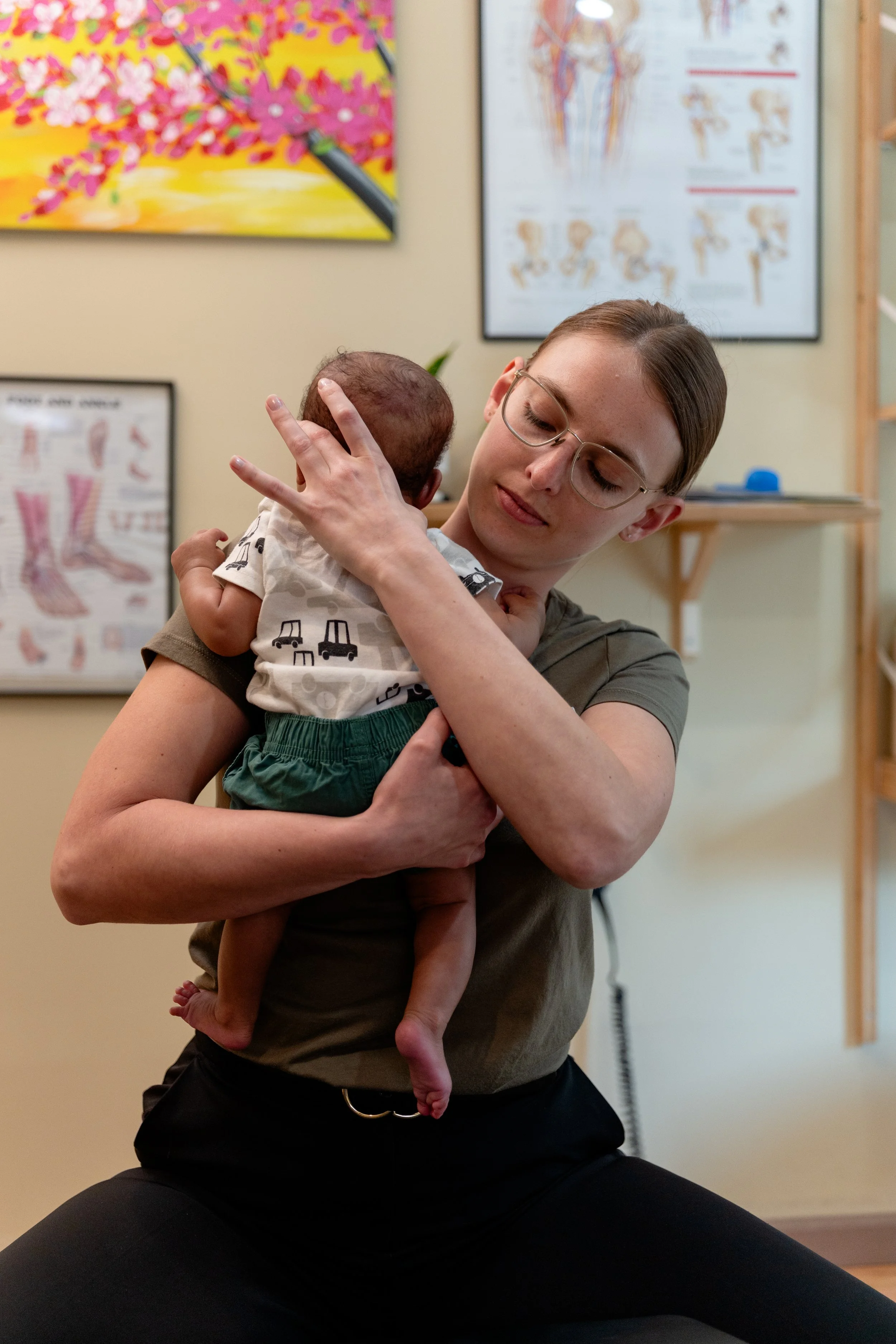 Webster certified chiropractor Dr. Mae Duba performing a gentle newborn chiropractic adjustment at Brewerytown Chiropractic in Philadelphia