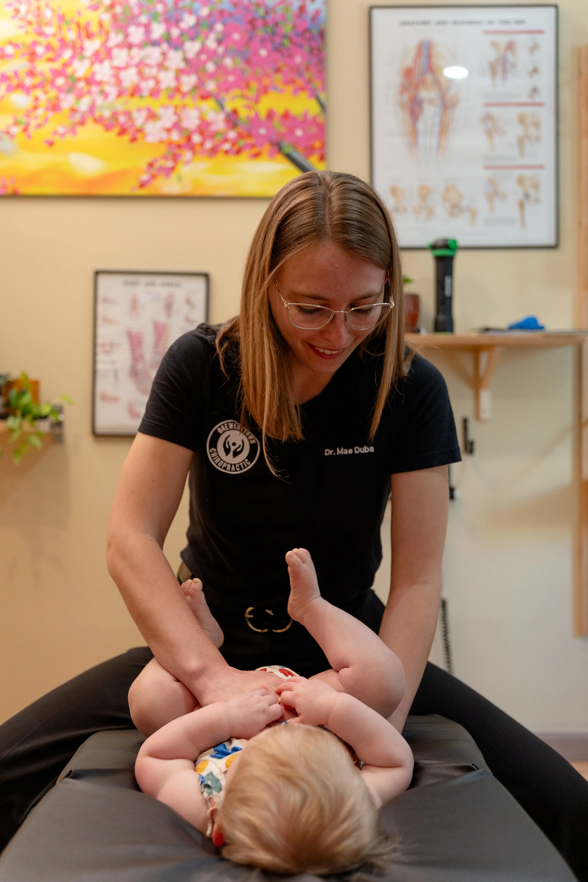 Pediatric chiropractor Dr. Mae Duba providing gentle infant chiropractic care at Brewerytown Chiropractic Philadelphia.