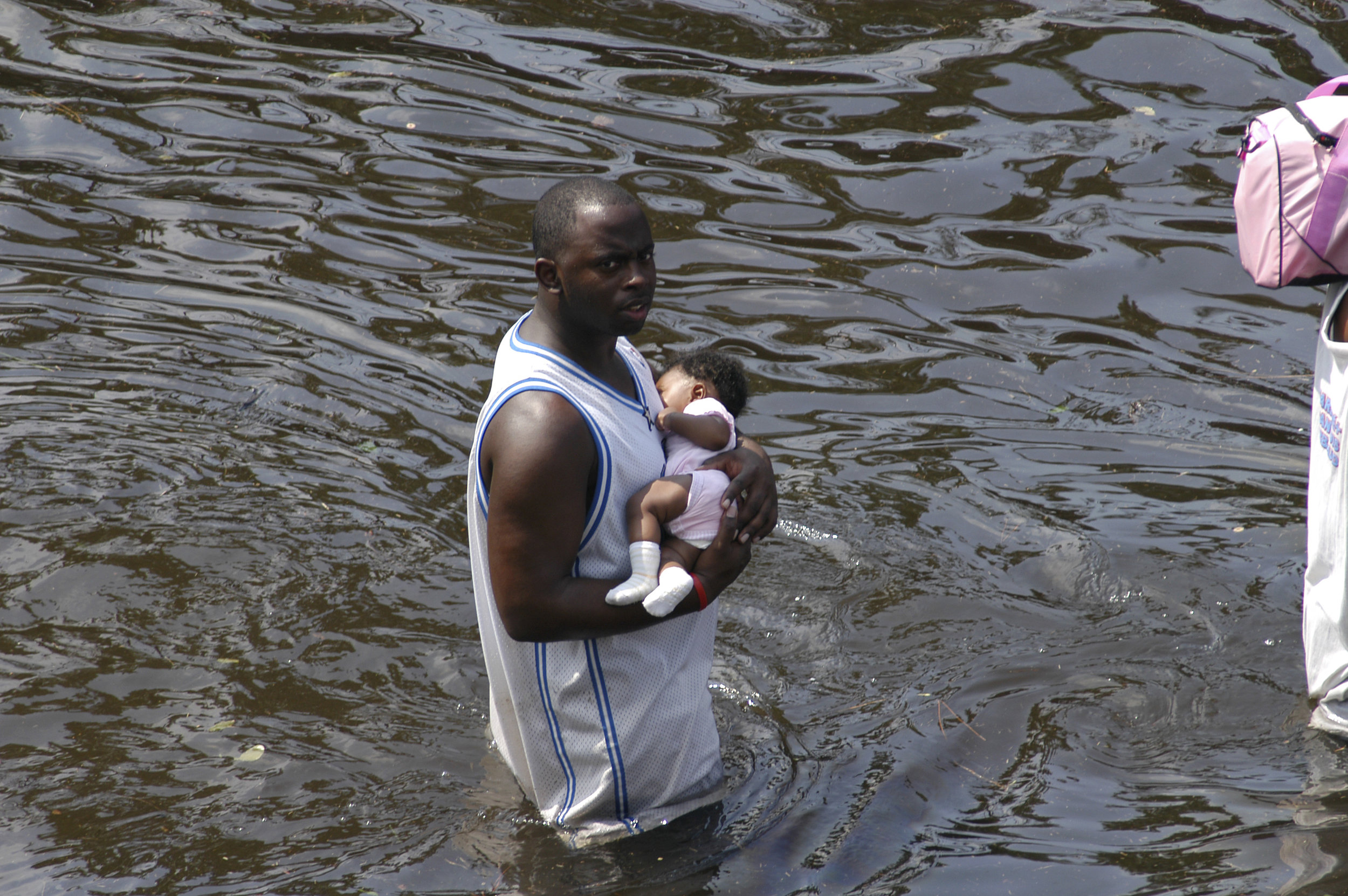 US_Navy_050831-N-8154G-198_A_man_carries_a_baby_through_the_flooded_streets_of_New_Orleans_outside_the_cities_Super_Dome_football_stadium.jpg