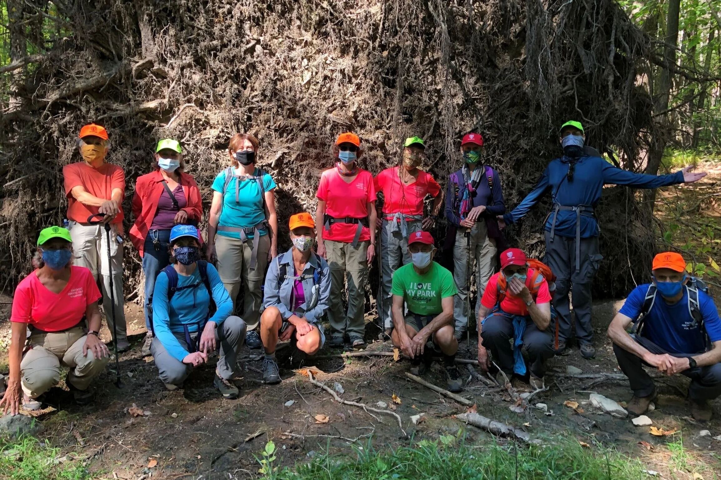 Picture taken on hike around Shaver Pond, in front of the roots of a huge blow down, many THC Volunteer hats in evidence! Pic by K Cedar