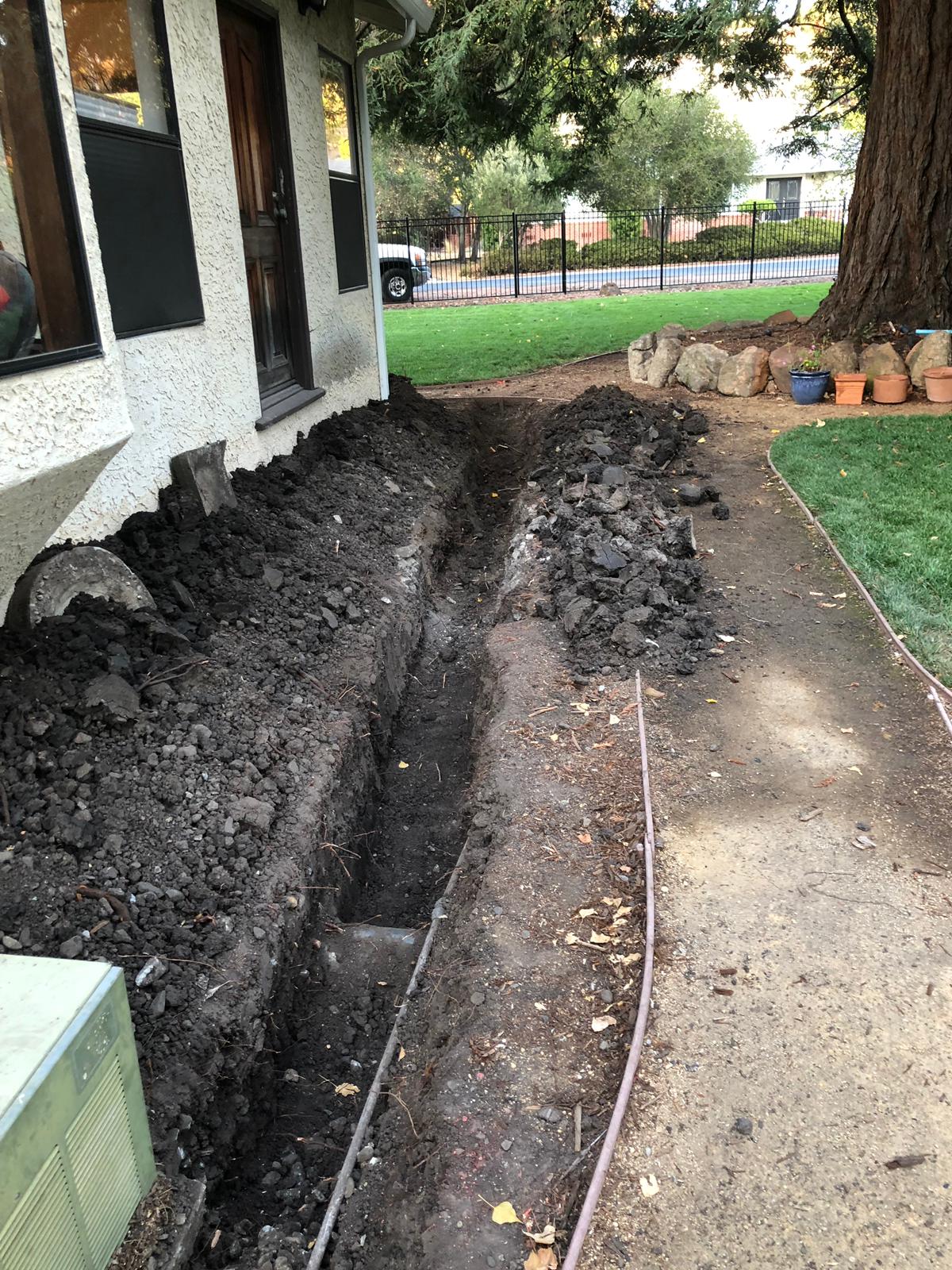  French drain repairs being done to a home.  