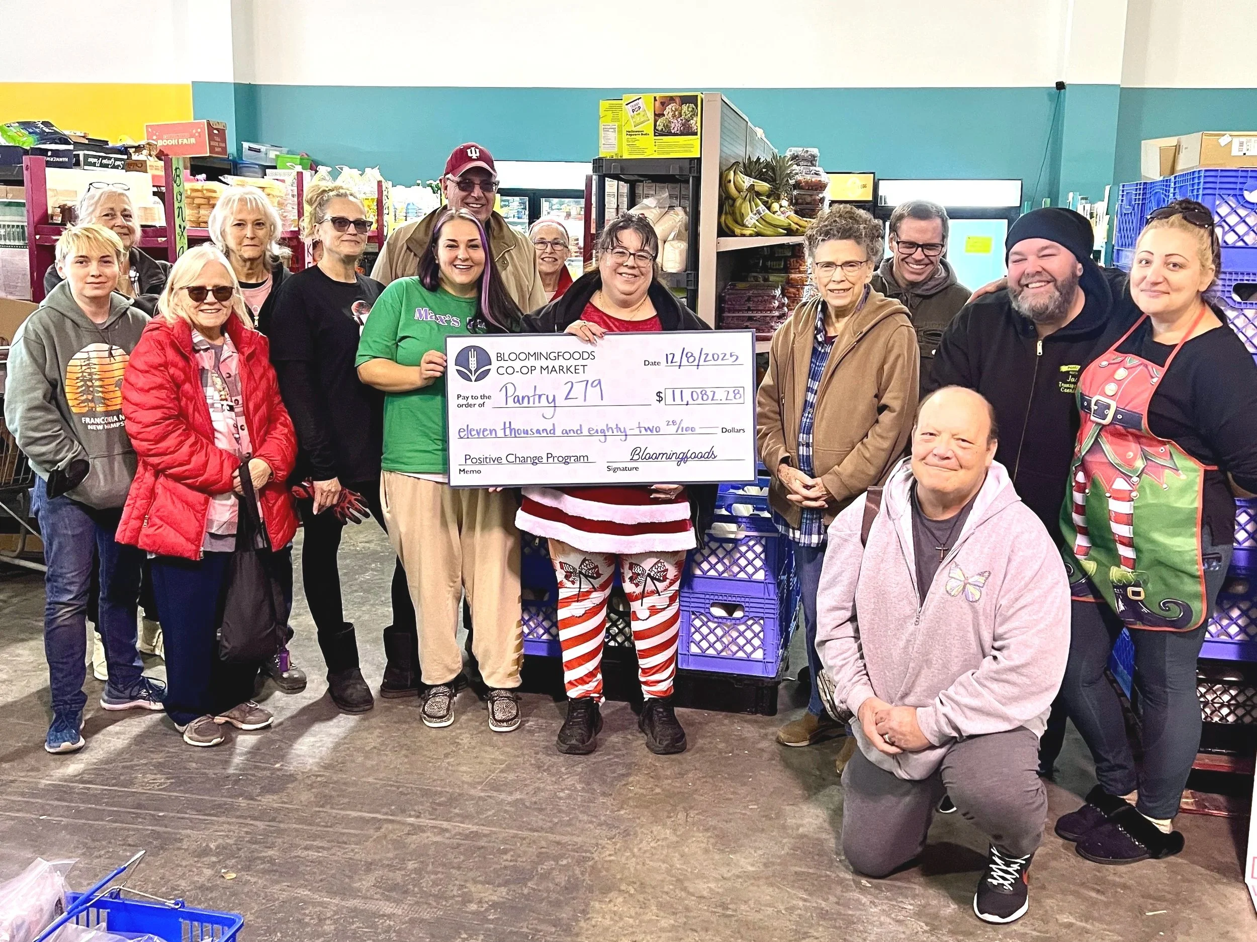 Pantry 279 volunteers pose with our Positive Change check