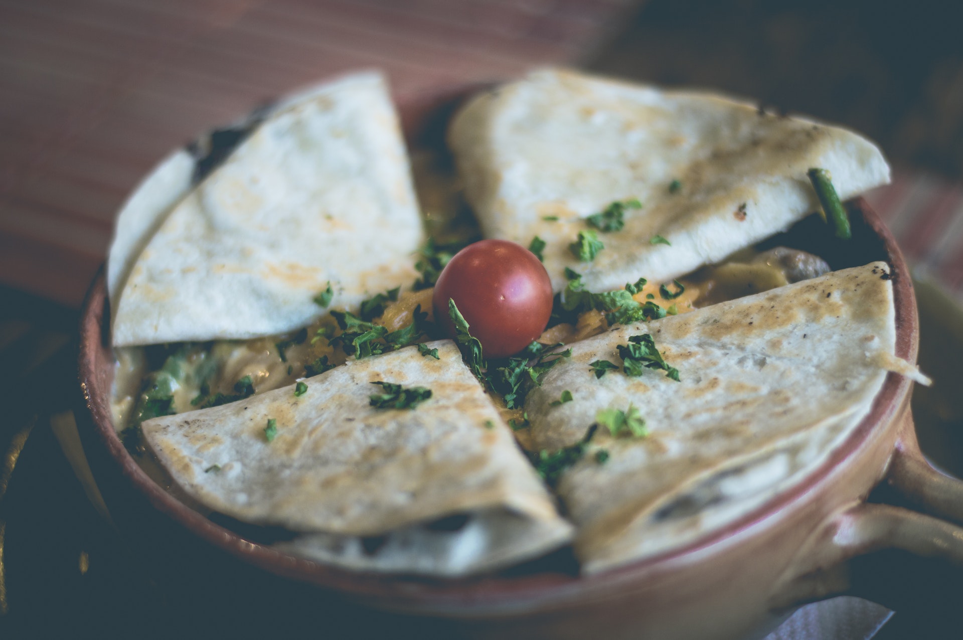 Quesadillas garnished with cilantro and tomatoes