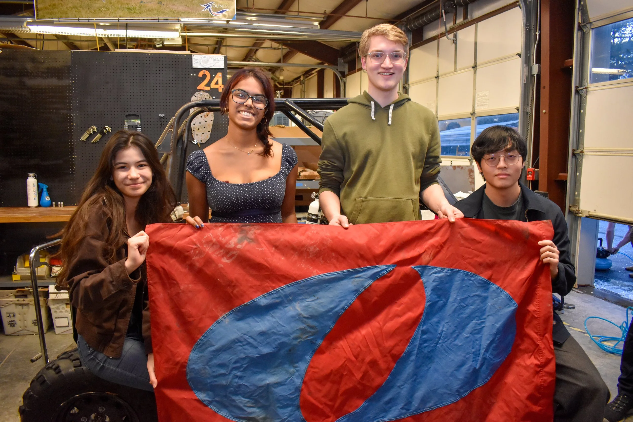 Olin Baja students holding Olin flag