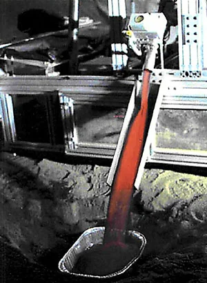 ROxygen reactor pouring out hot soil after reaction with hydrogen to produce oxygen. An example of hydrogen reduction of regolith. Credit: Johnson Space Center/ Kennedy Space Center.