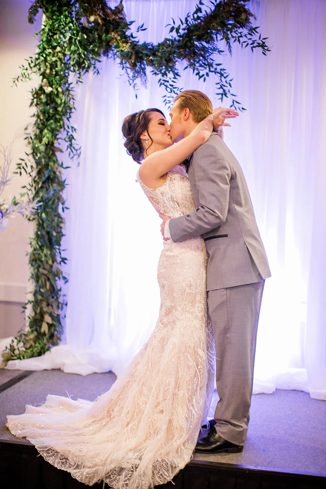 get married on a stage platform with draped backdrop | photo by Rachel Graff Photography | Royal Cliff in Eagan