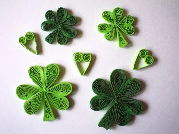 Shamrocks in light and dark greens made from paper quilling, the art of rolling and shaping paper strips