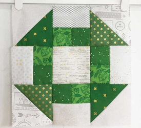 Church Dash quilt square, a nine patch in green and white that resembles the dasher in a butter churn