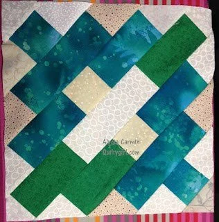 Blue-green and white quilt block with a white x in the center