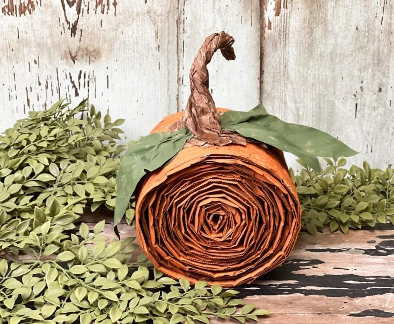 Pumpkin decoration made from rolled cardboard and lunch bags