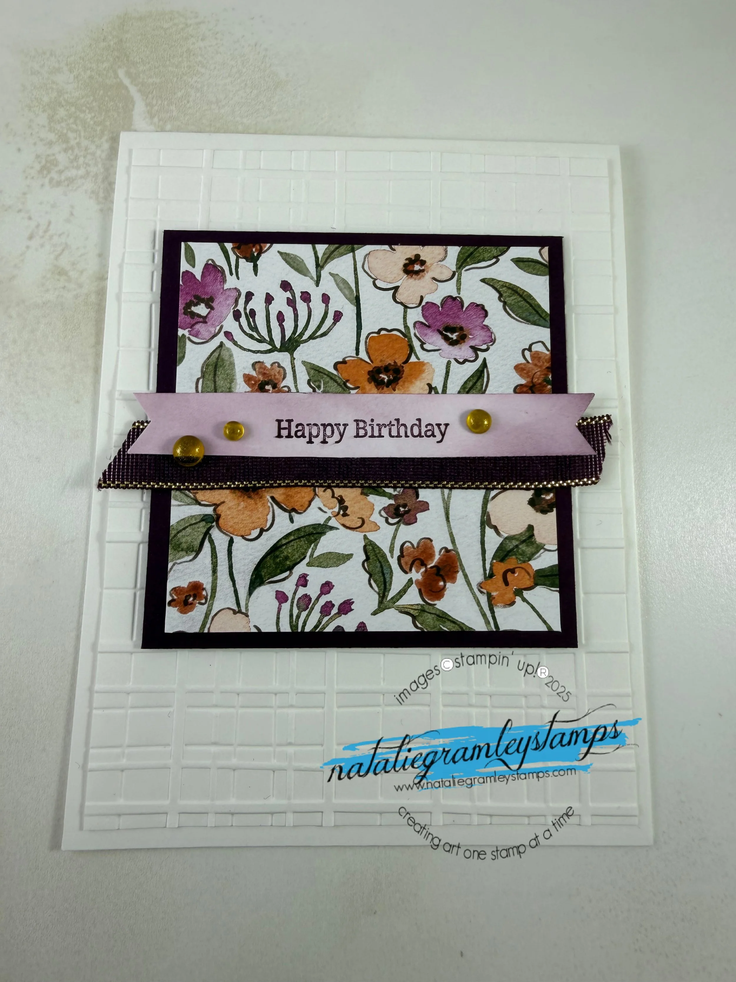 Greeting card in white with a square of flowers says Happy Birthday