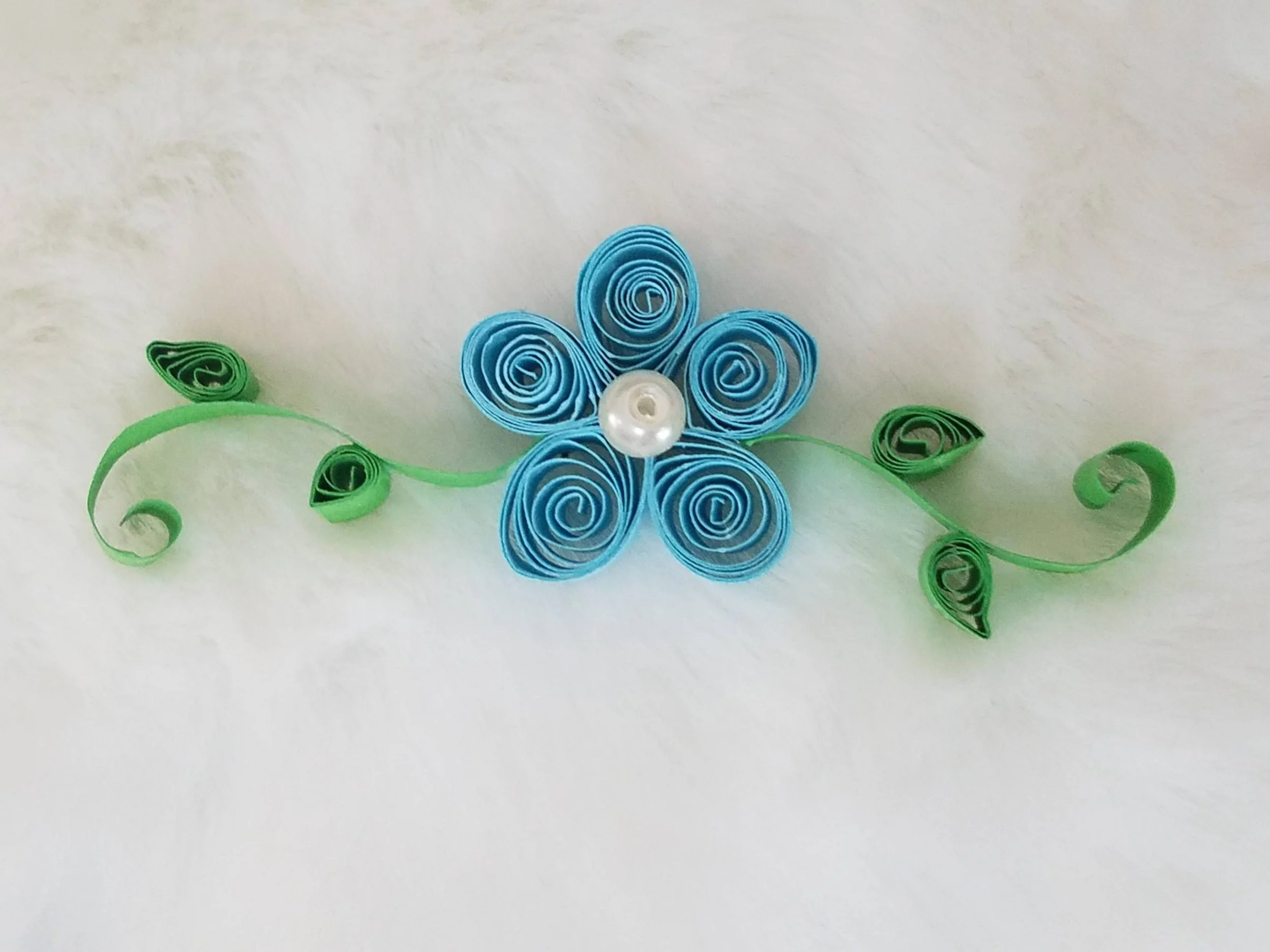 Quilling flower in blue with green vines