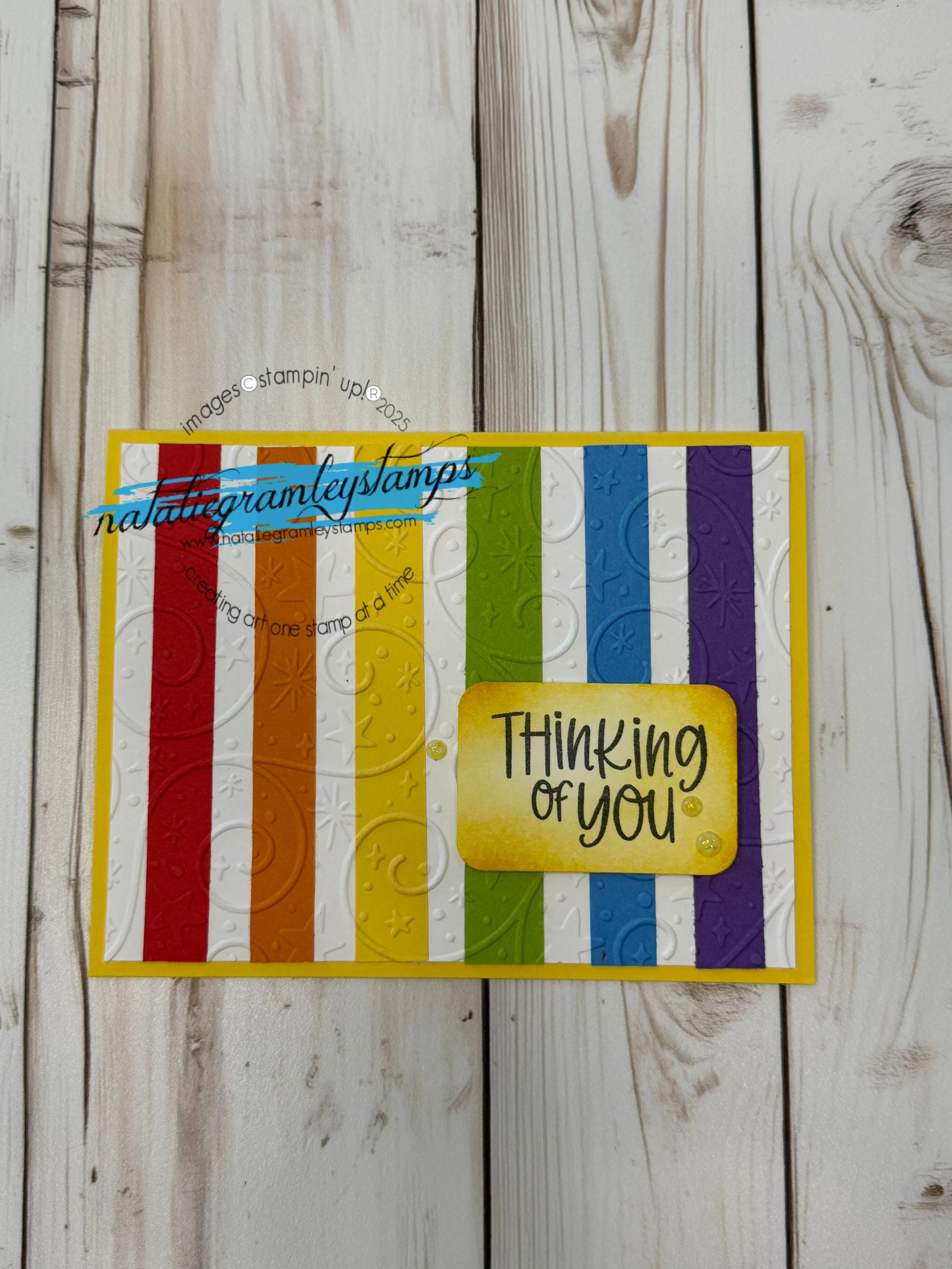 Greeting card with bright rainbow stripes and "Thinking of You" in a yellow rectangle