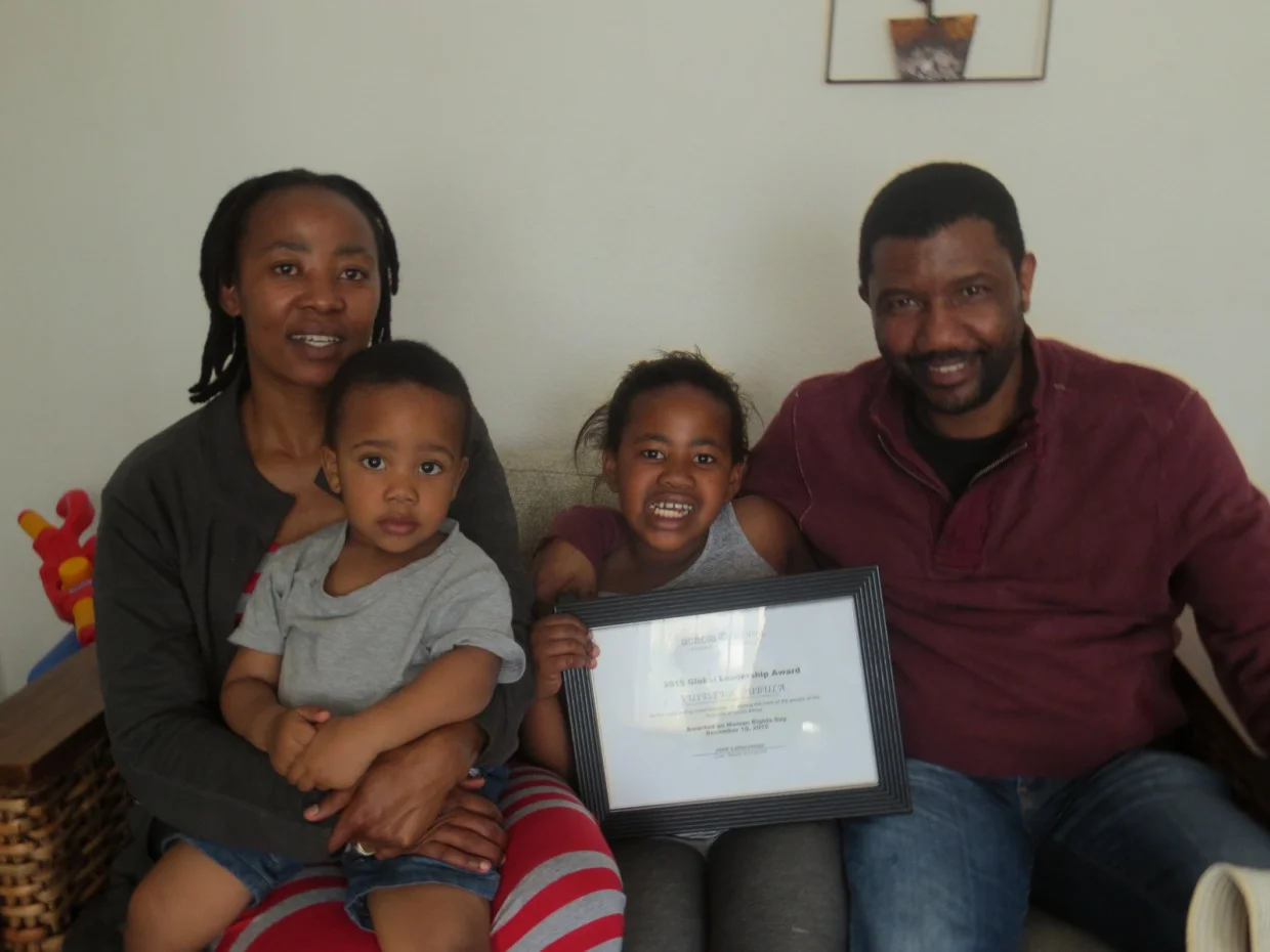 Vuyiseka Dubula and Mandla Majola, with their children and Vuyiseka’s “2016 Global Leadership Award.”