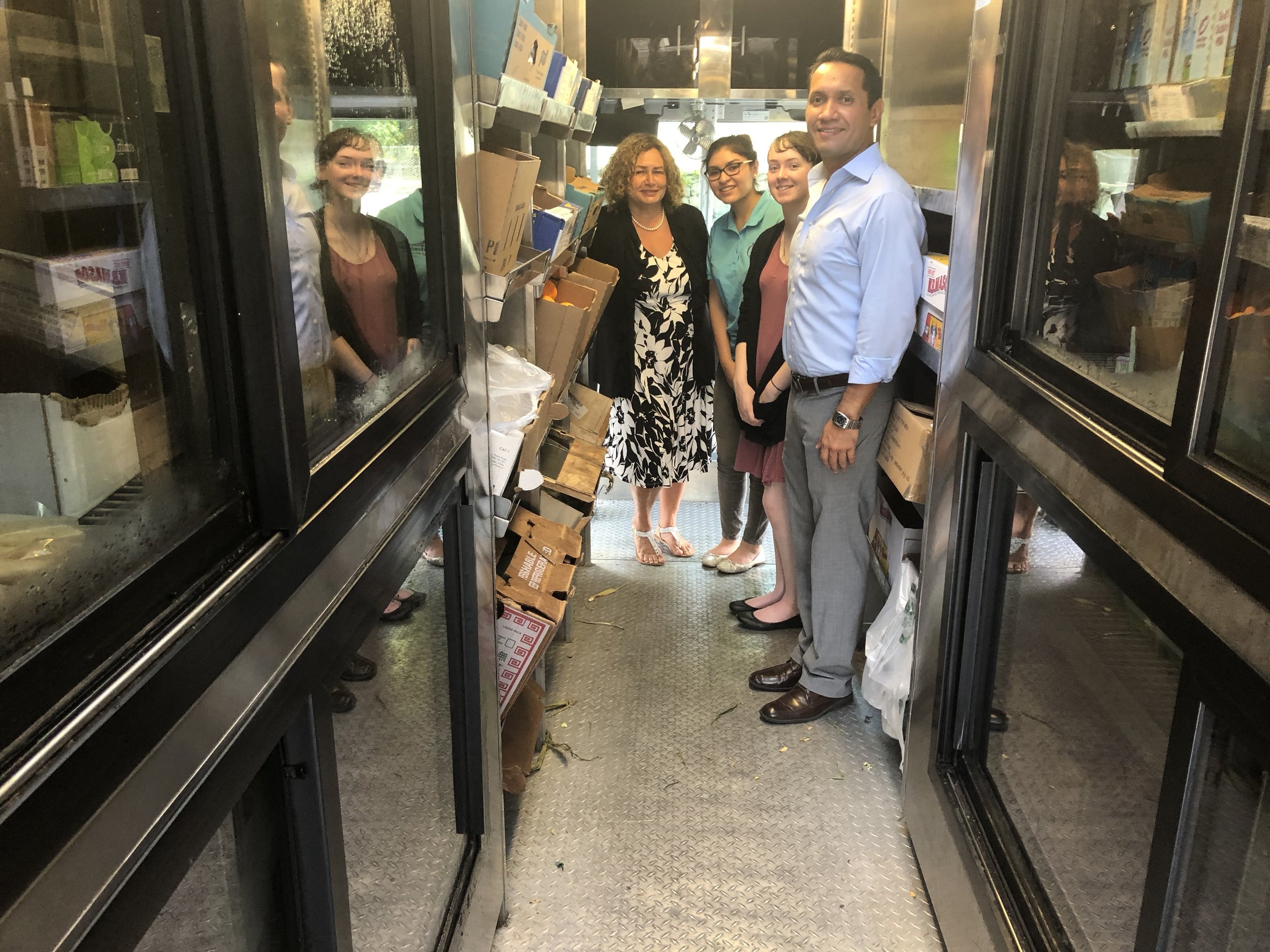 Group of people smiling in a hallway