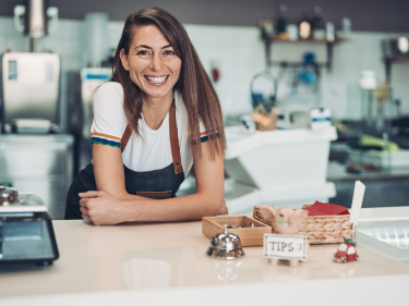 Entrepreneur woman smiling in a cafeteria counter