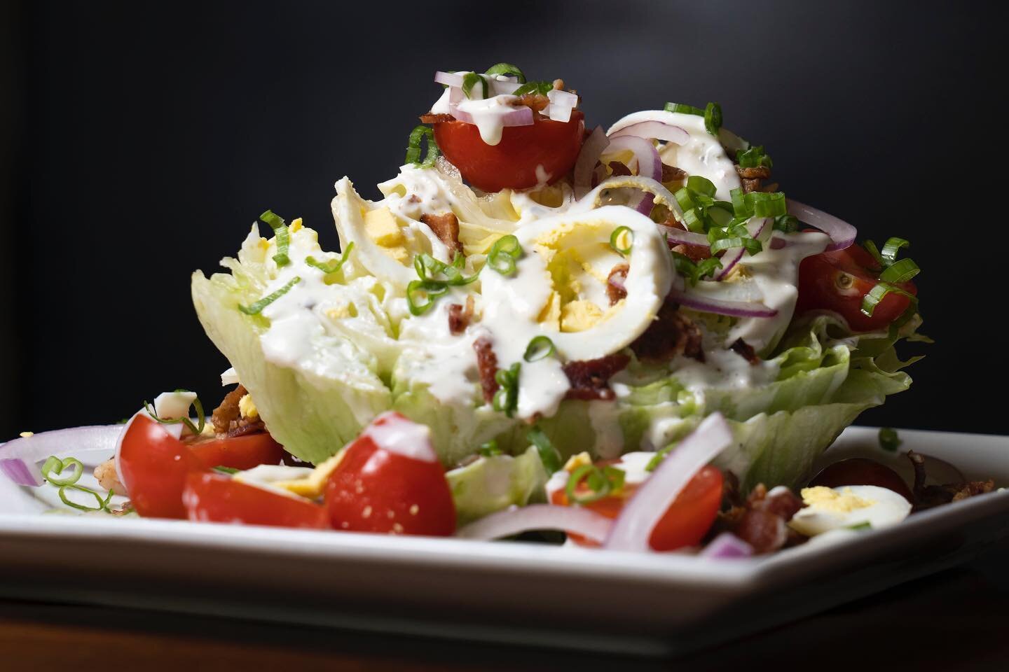 Our Great Green Wedge Salad is waiting for you! Iceberg lettuce, smoked bacon, cherry tomatoes, hardboiled eggs, red onion, and green onions drizzled in your choice of ranch or blue cheese. Today we are open from 4-9pm with indoor/outdoor dinging alo