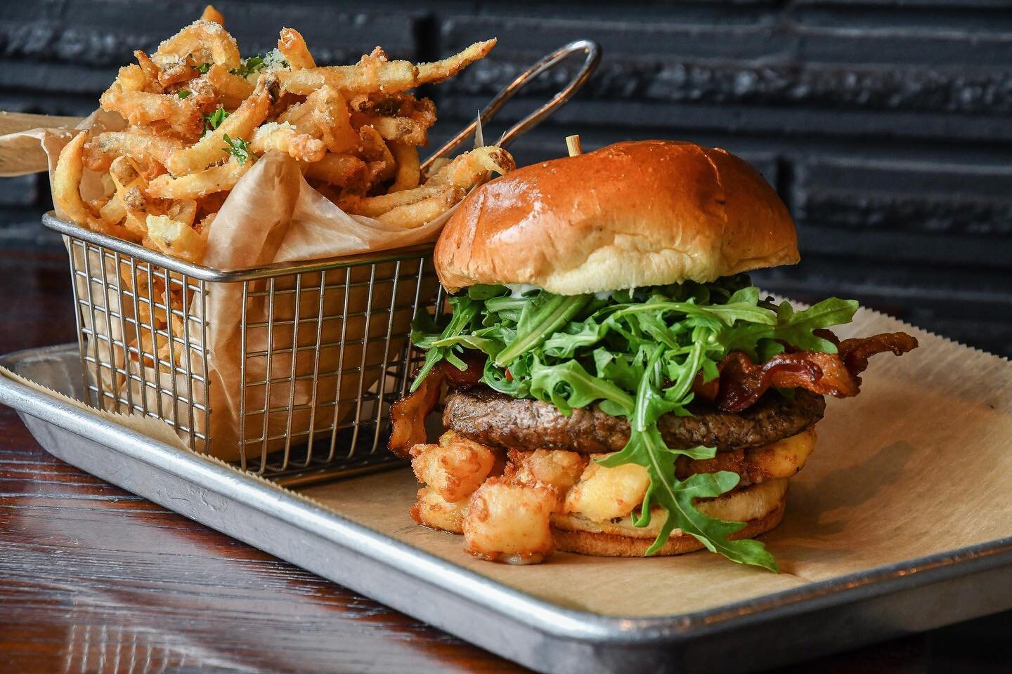 Sometimes all you need is a good burger and fries, and we&rsquo;ve got you covered! Featured here is our Taste Bud burger made with our signature Angus beef blend of chuck, short rib and brisket topped with applewood-smoked bacon, roasted tomatoes, c