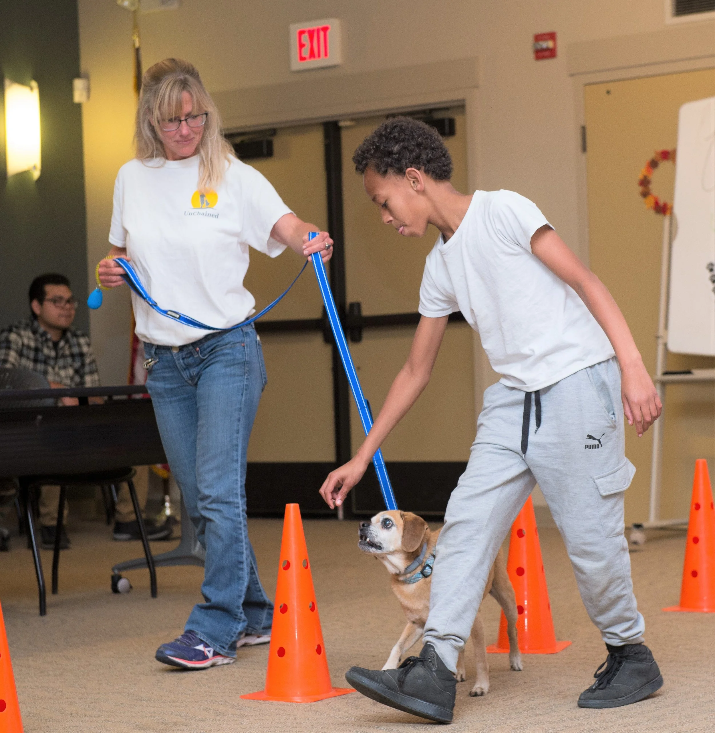 “ When we inspire young people to be their best people by caring for others s uch as dogs in need, we are building a community of compassion and a future of hope for all peop le. By working with underserved youth, UnChained puts the dogs and youth in the driver seat to offer each other second chances to a better life. ”