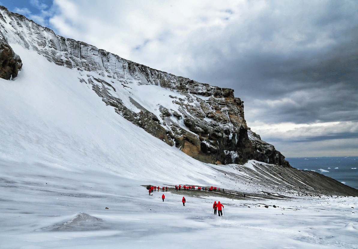 Descending hikers from a vigorous glacier hike on the south side of Brown Bluff.